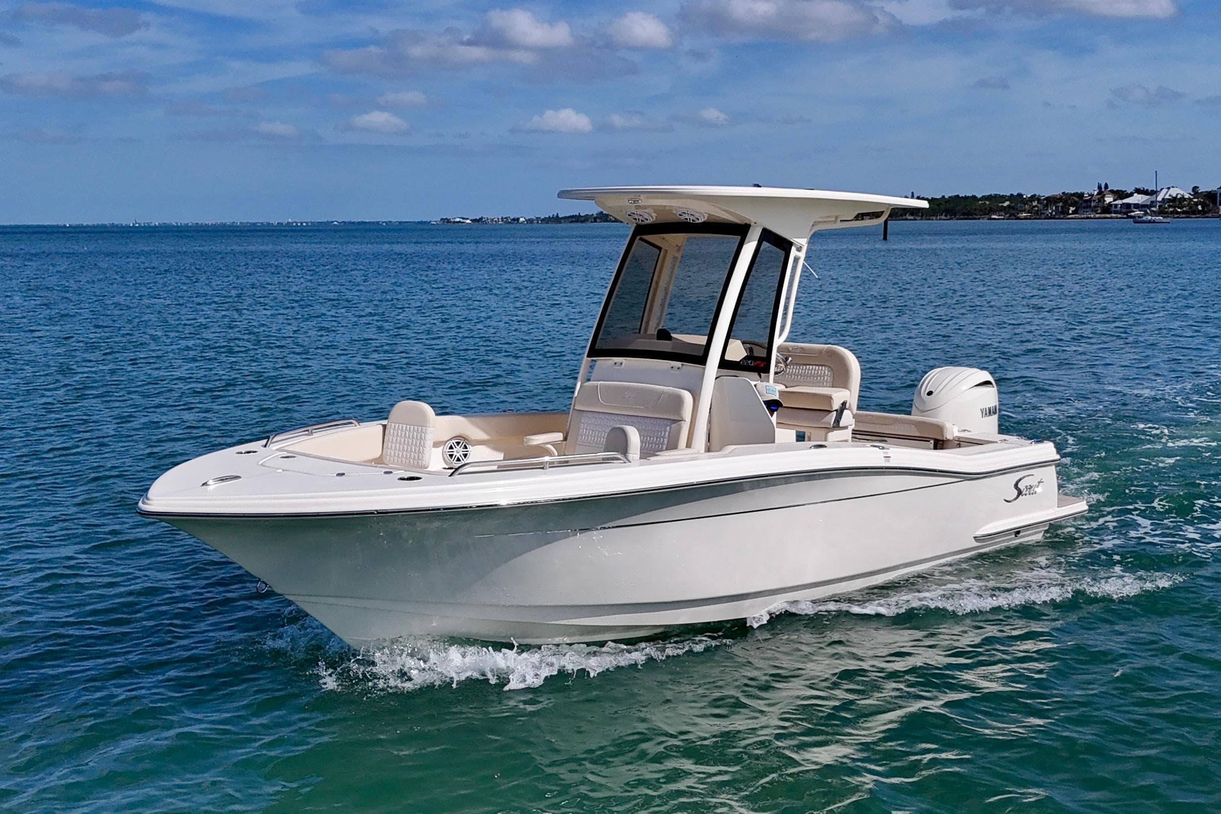 2026 Scout 220 XSF boat cruising on clear blue water under a sunny sky.