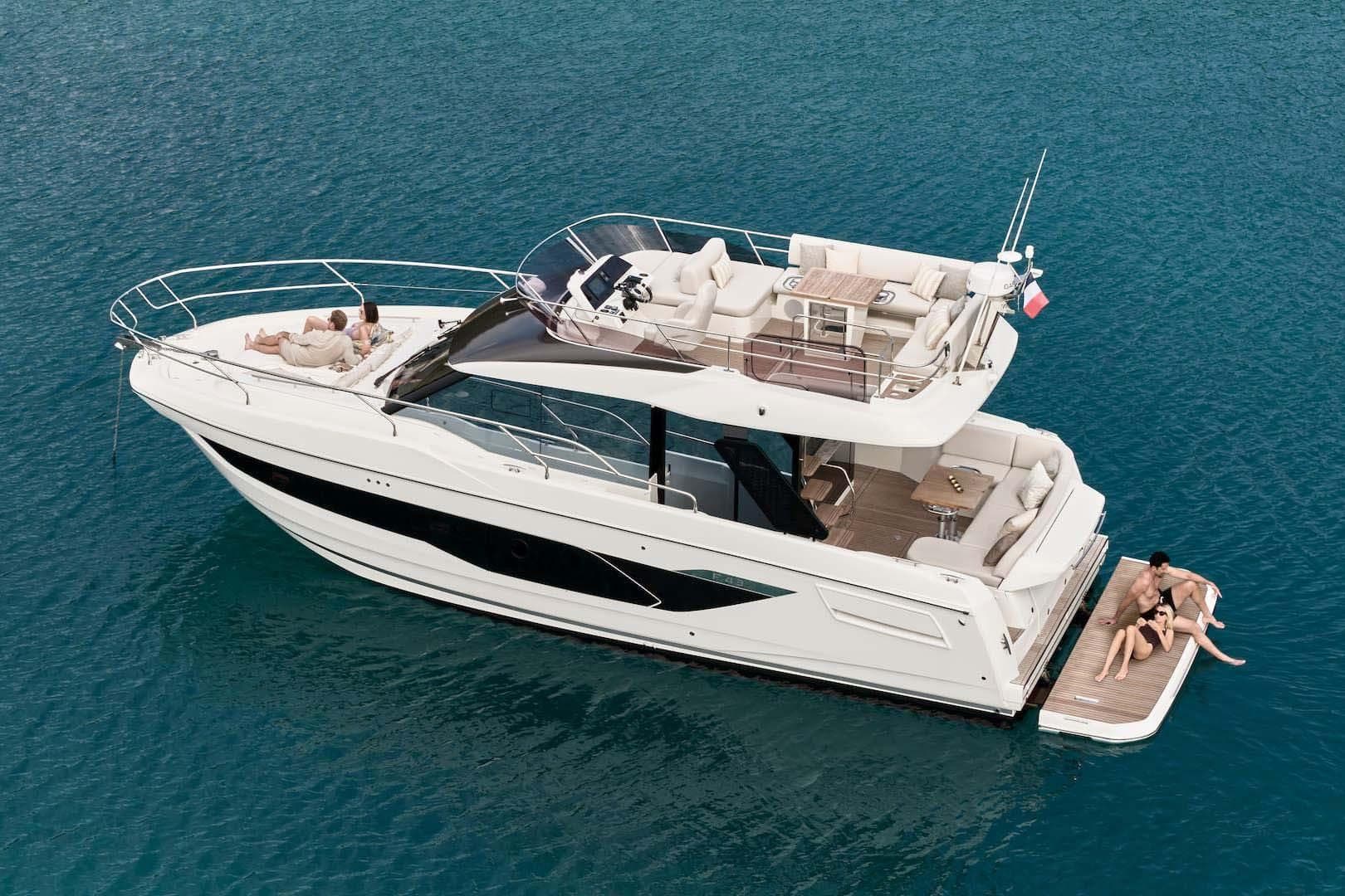 Manufacturer Provided Image: Luxurious 2026 Prestige F4.3 yacht on serene blue waters, featuring spacious deck and lounging area.