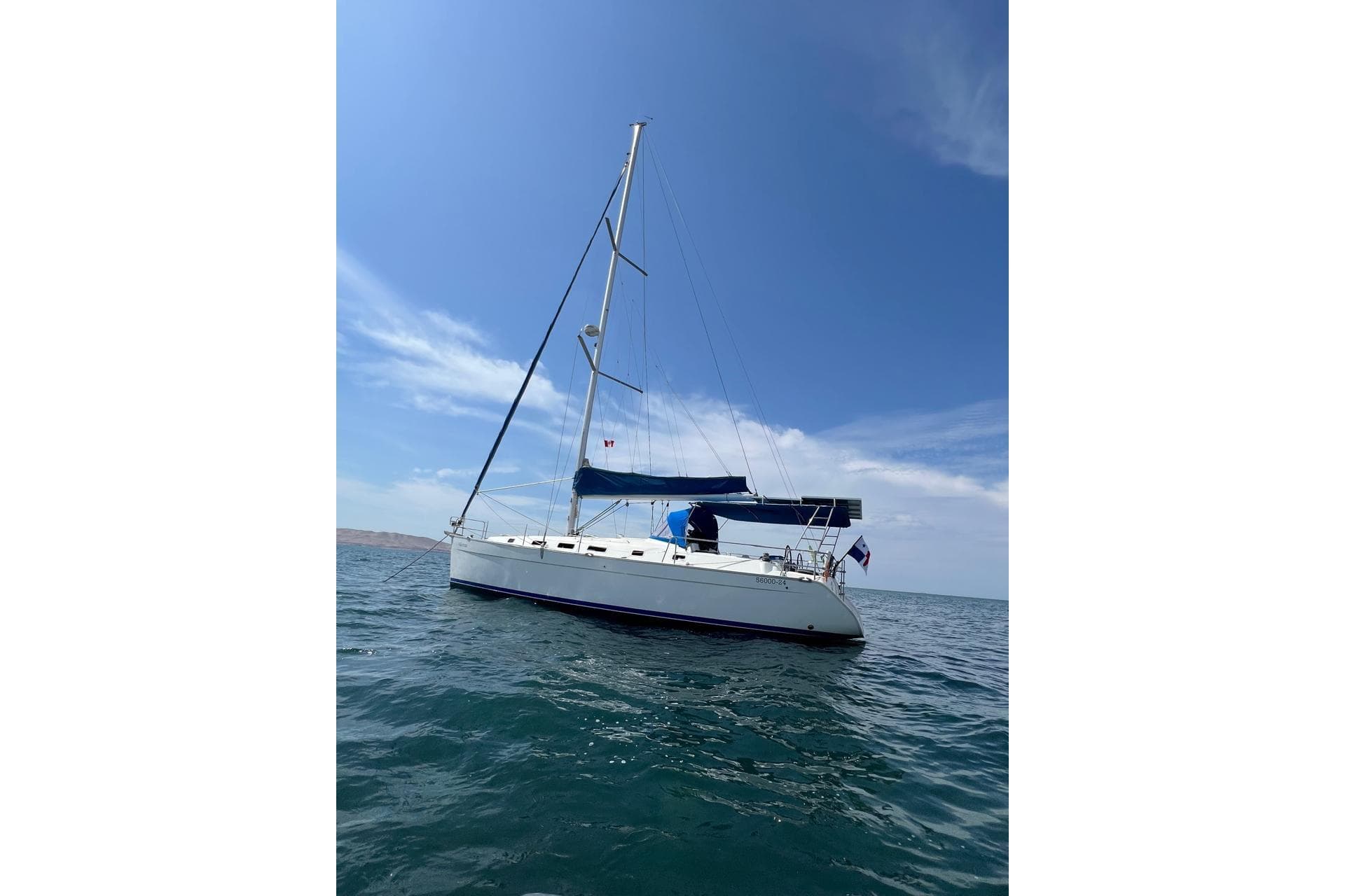 2006 Beneteau Cyclades 43.3 sailboat on open water under clear blue sky.