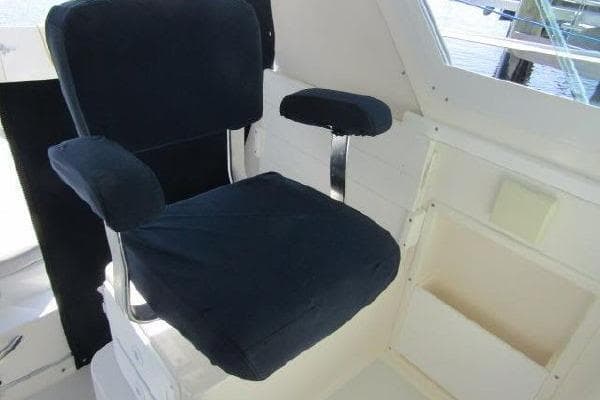 Captain's chair on 2000 Albin 28 Tournament Express boat, featuring black upholstery.
