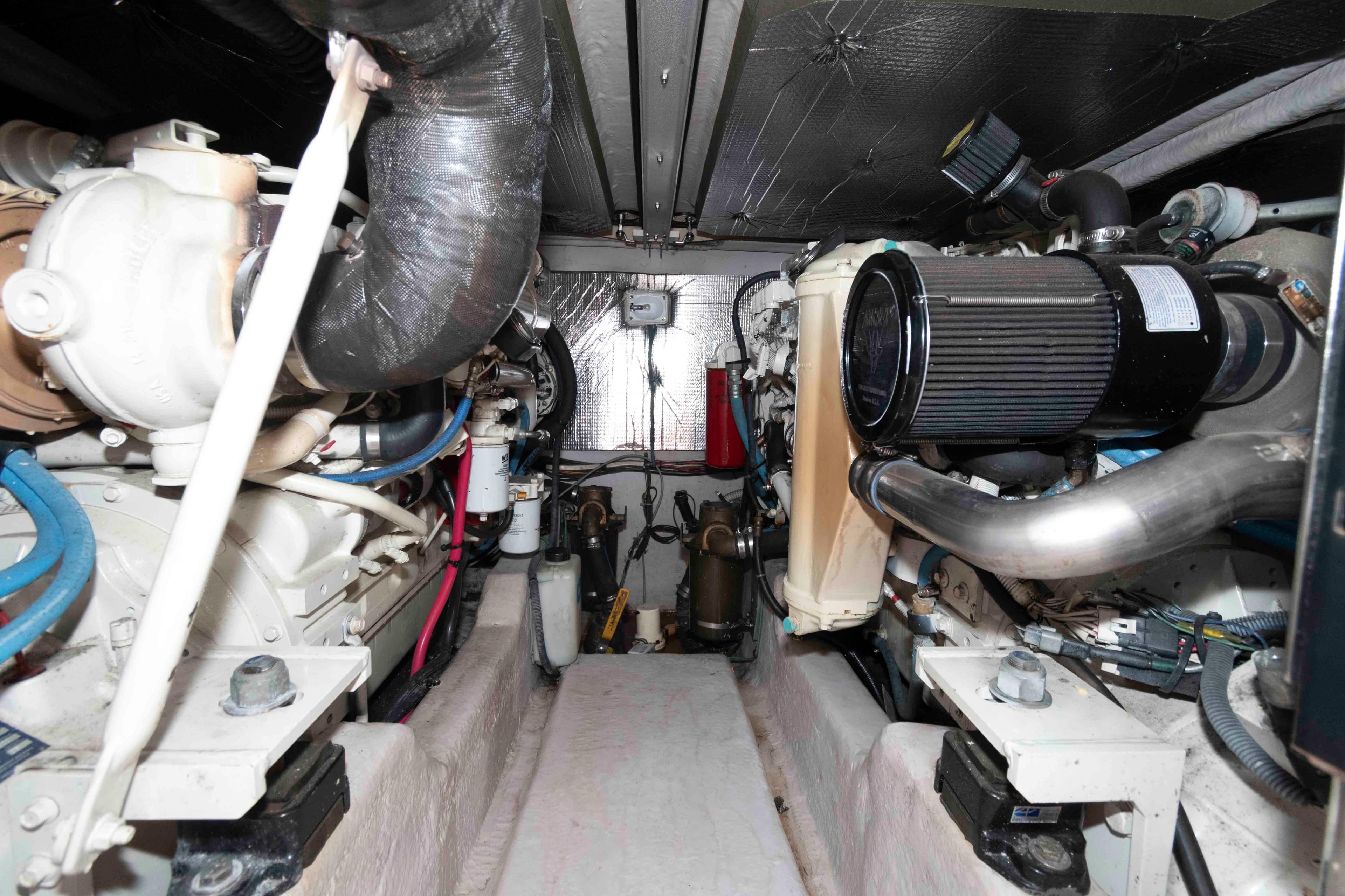 Engine room of 2005 Sea Ray 420 Sedan Bridge, showcasing mechanical components and systems.