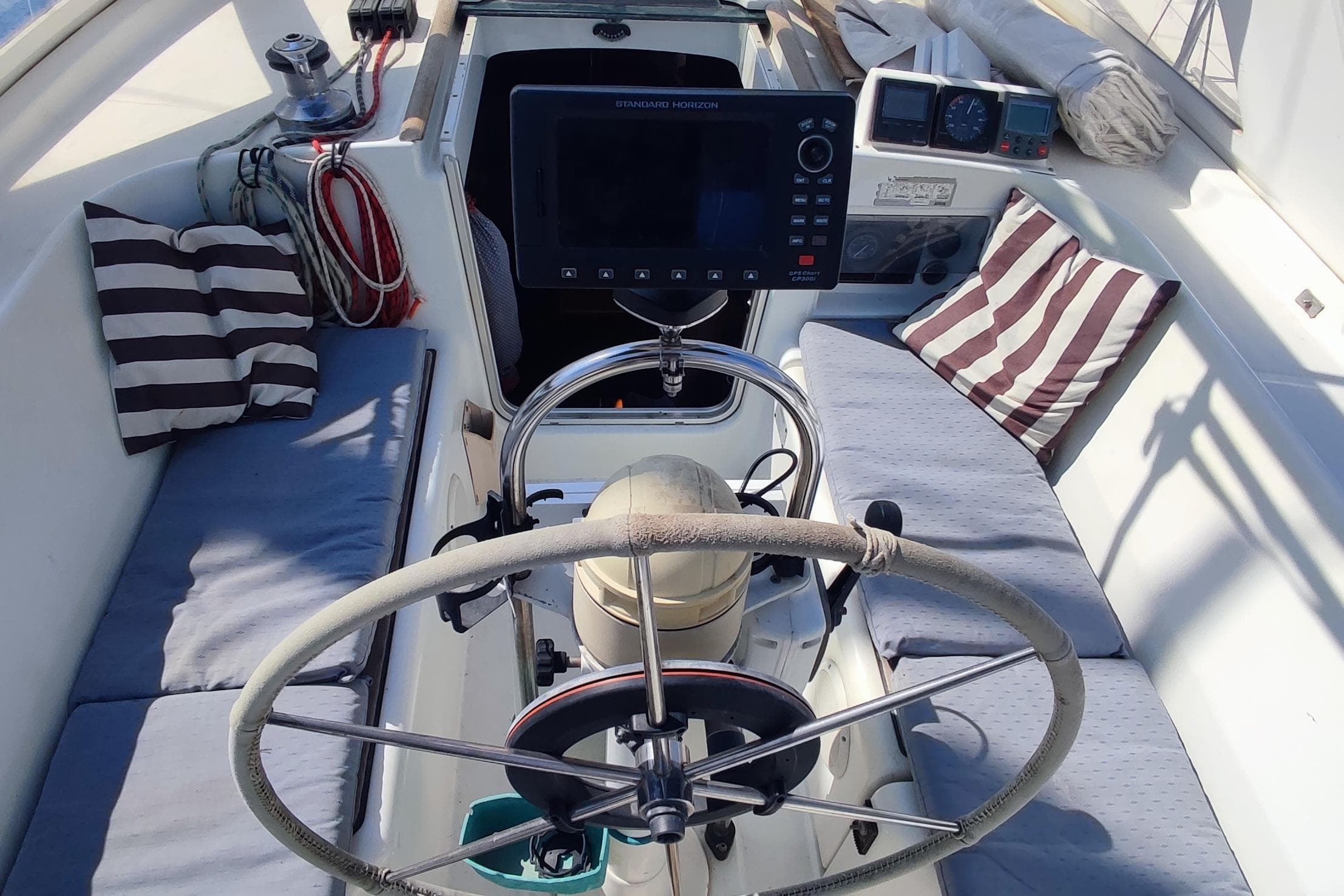 Cockpit of 1997 Beneteau Oceanis 36 CC sailboat with steering wheel and navigation equipment.