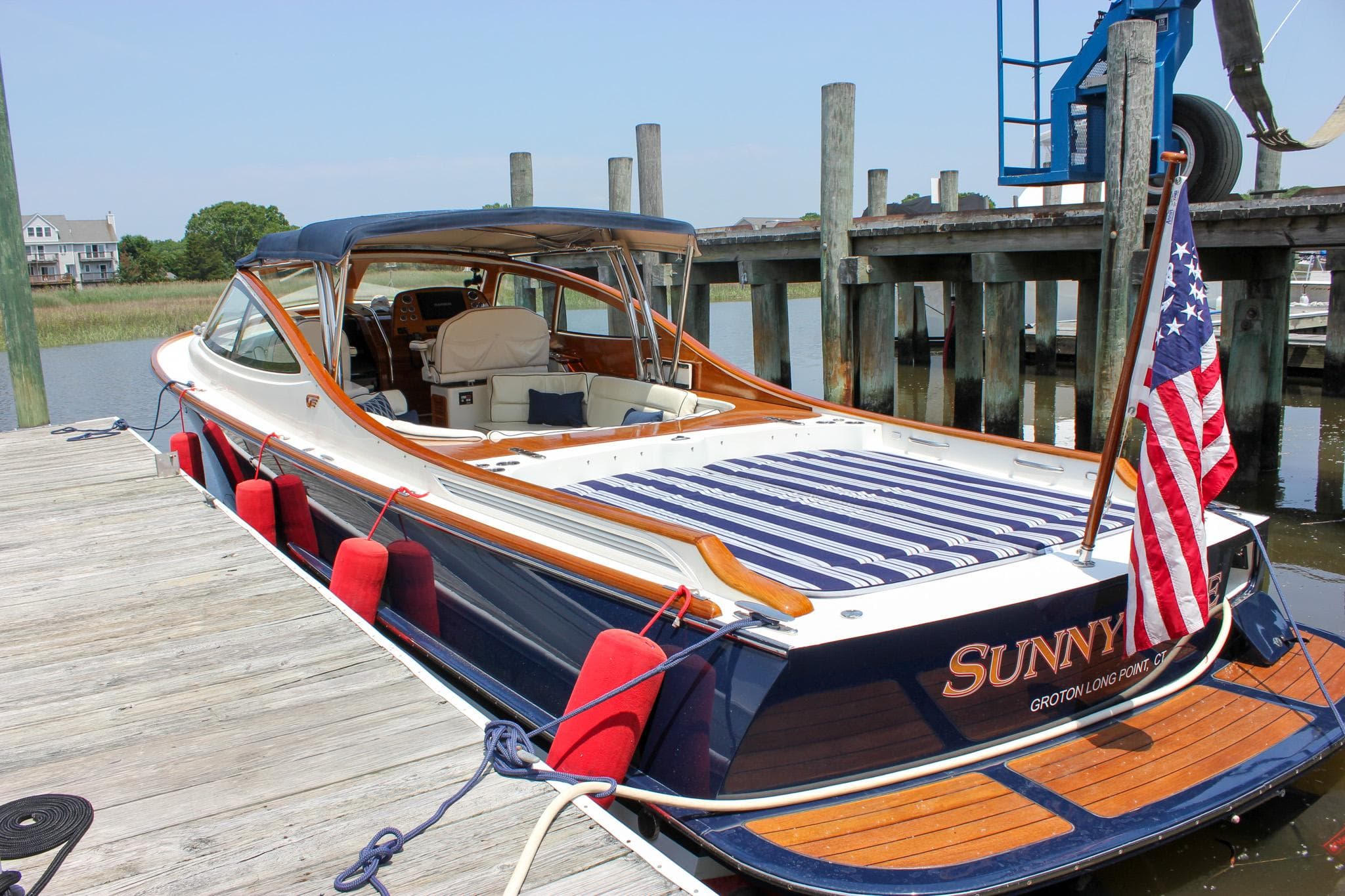 2008 Hinckley Talaria 38R Convertible docked, featuring elegant design and American flag.