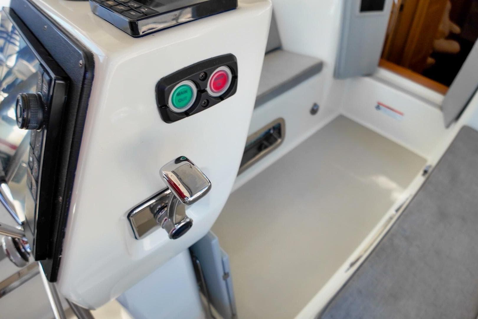 2023 Island Packet 439 yacht interior with control panel and seating area.