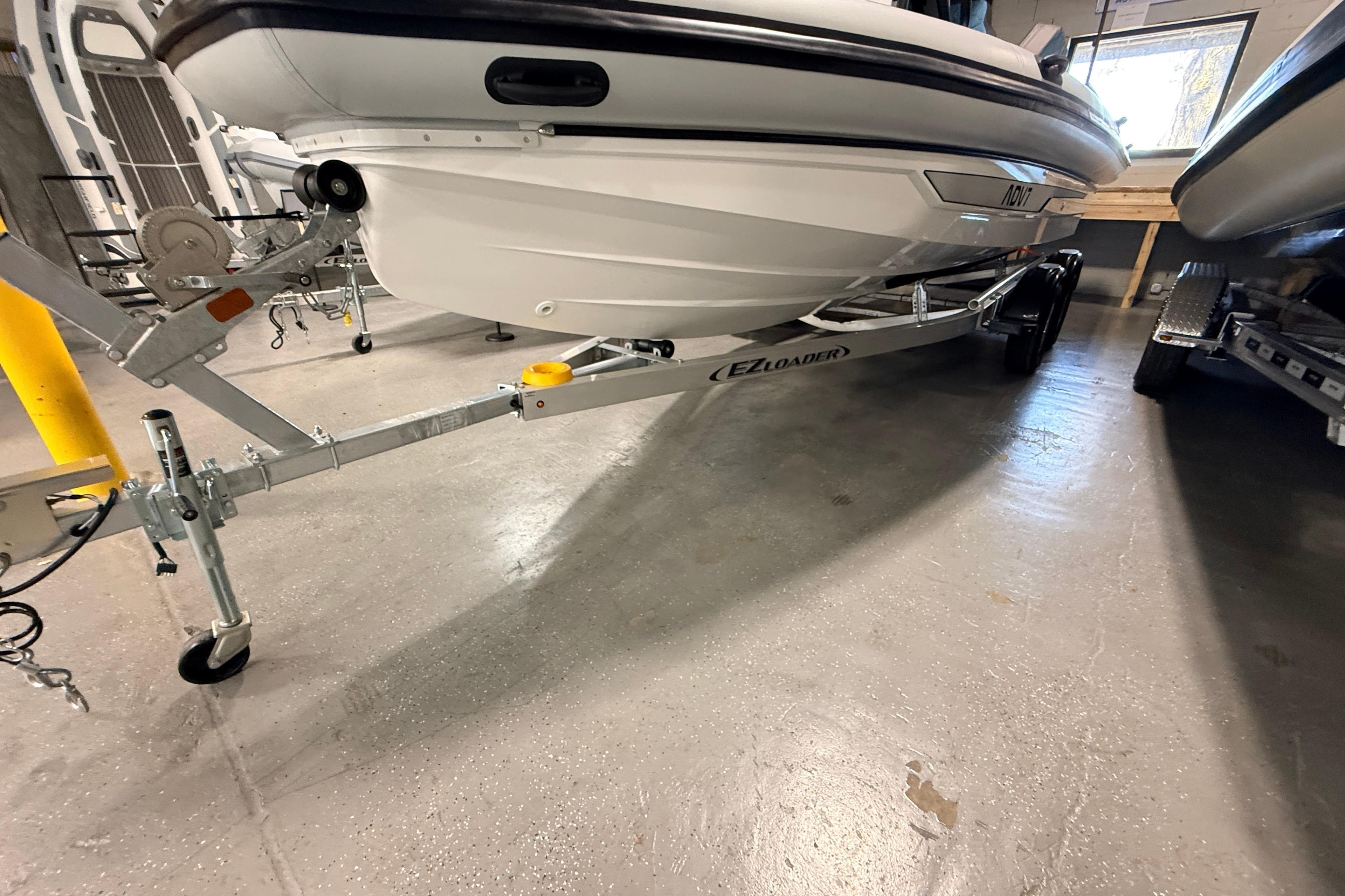 2026 Highfield ADV7 boat on EZ Loader trailer in indoor storage.