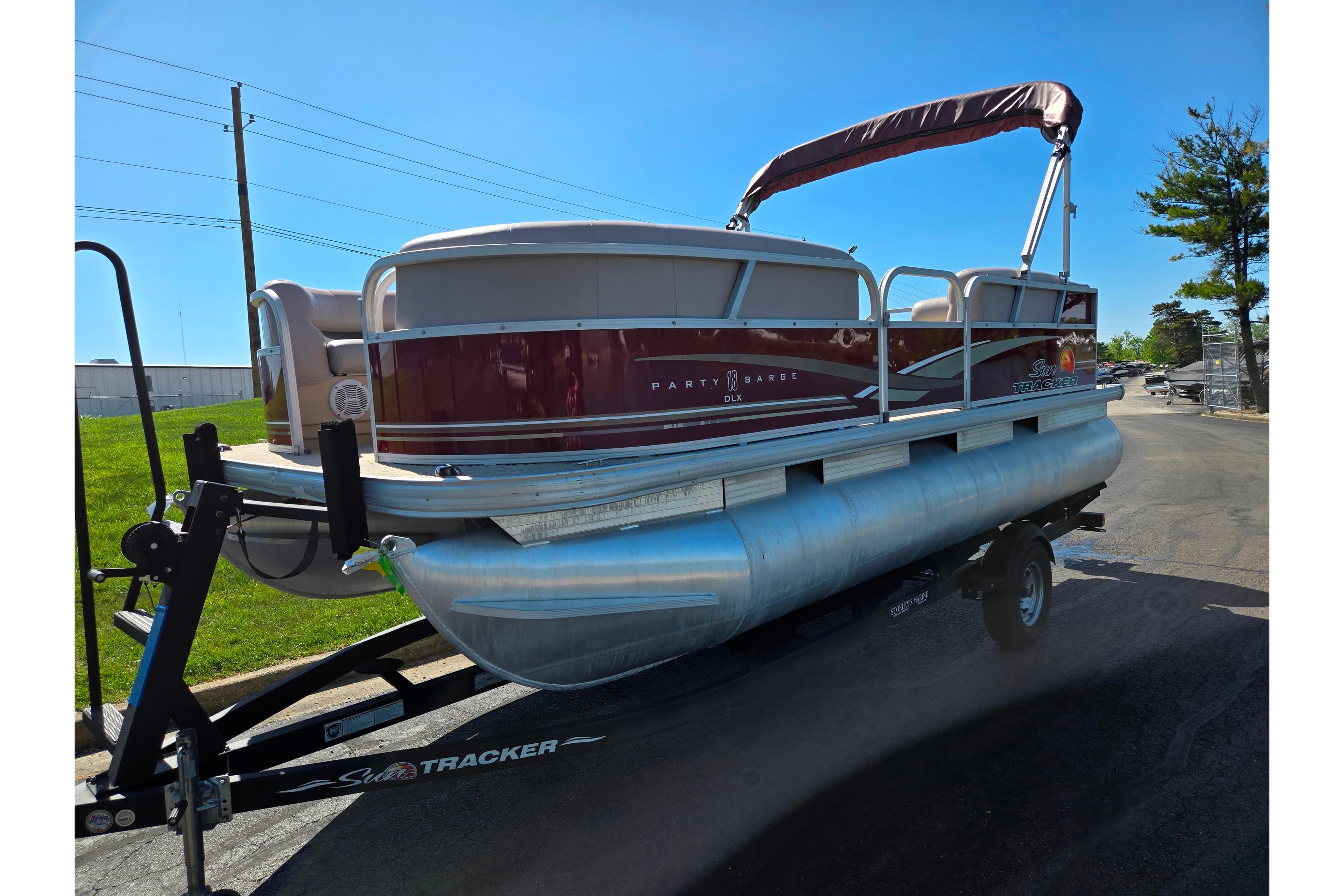 2014 Sun Tracker Party Barge 20 DLX pontoon boat on trailer, parked outdoors.