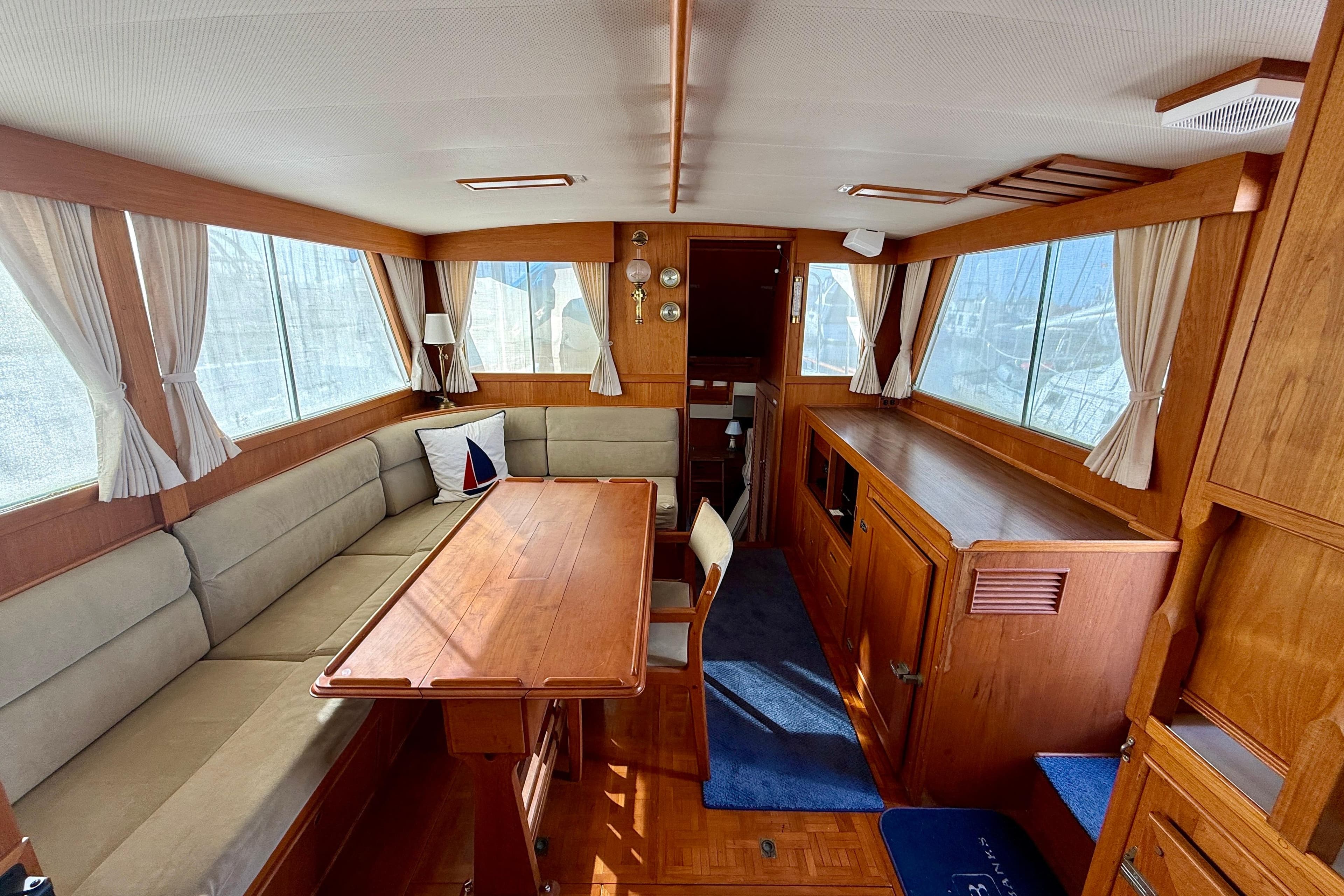 1982 Grand Banks Classic yacht interior with wood finish, dining area, and large windows.