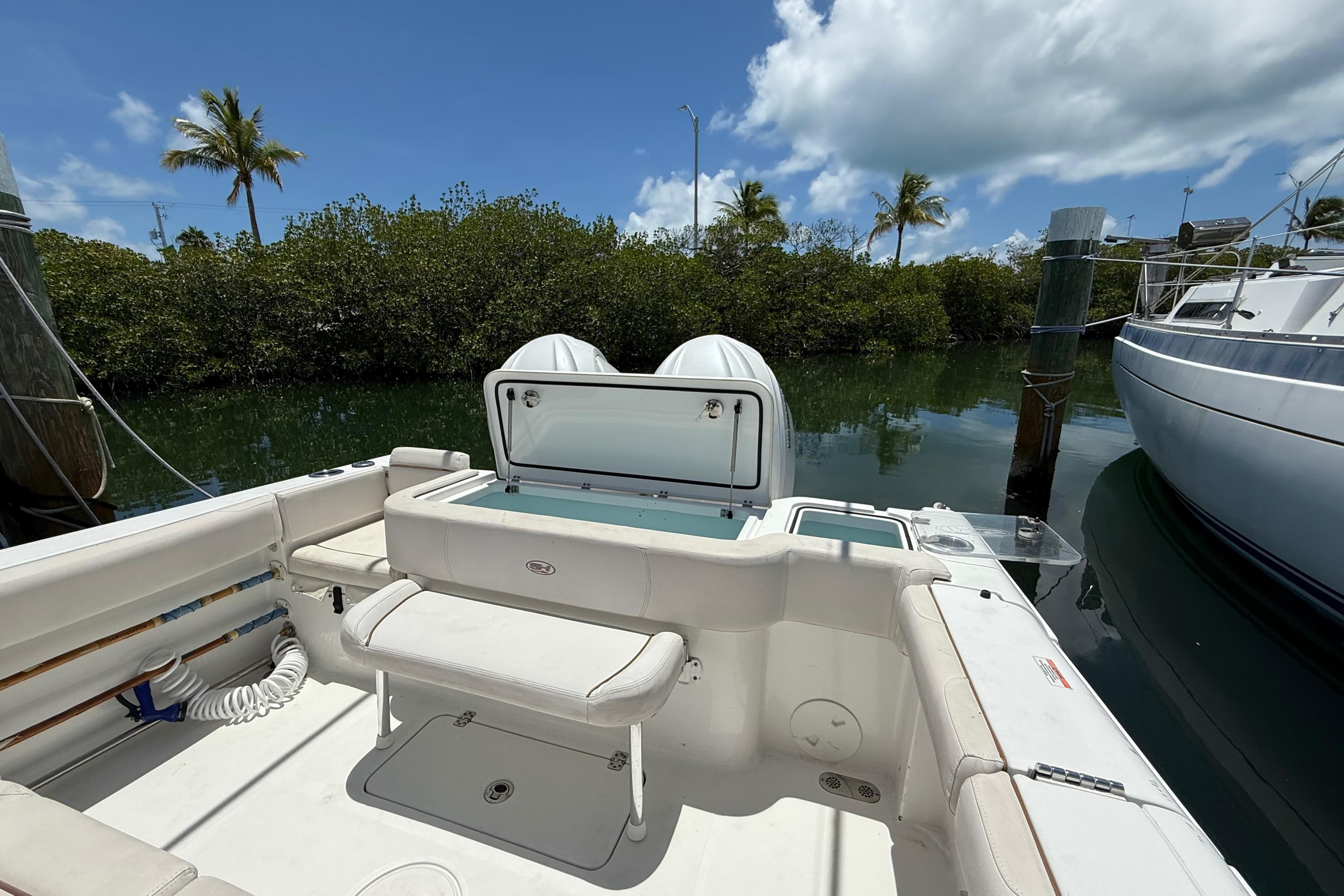 2022 Sea Hunt Gamefish 30 Coffin Box boat docked, featuring spacious seating and storage.