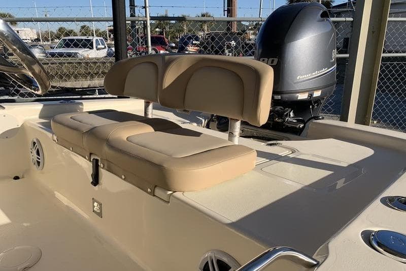 2025 Scout 177 Sport boat interior with beige seating and outboard motor.