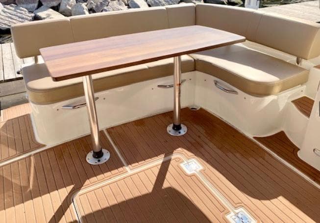 2016 Carver C37 yacht interior with beige seating and wooden table.