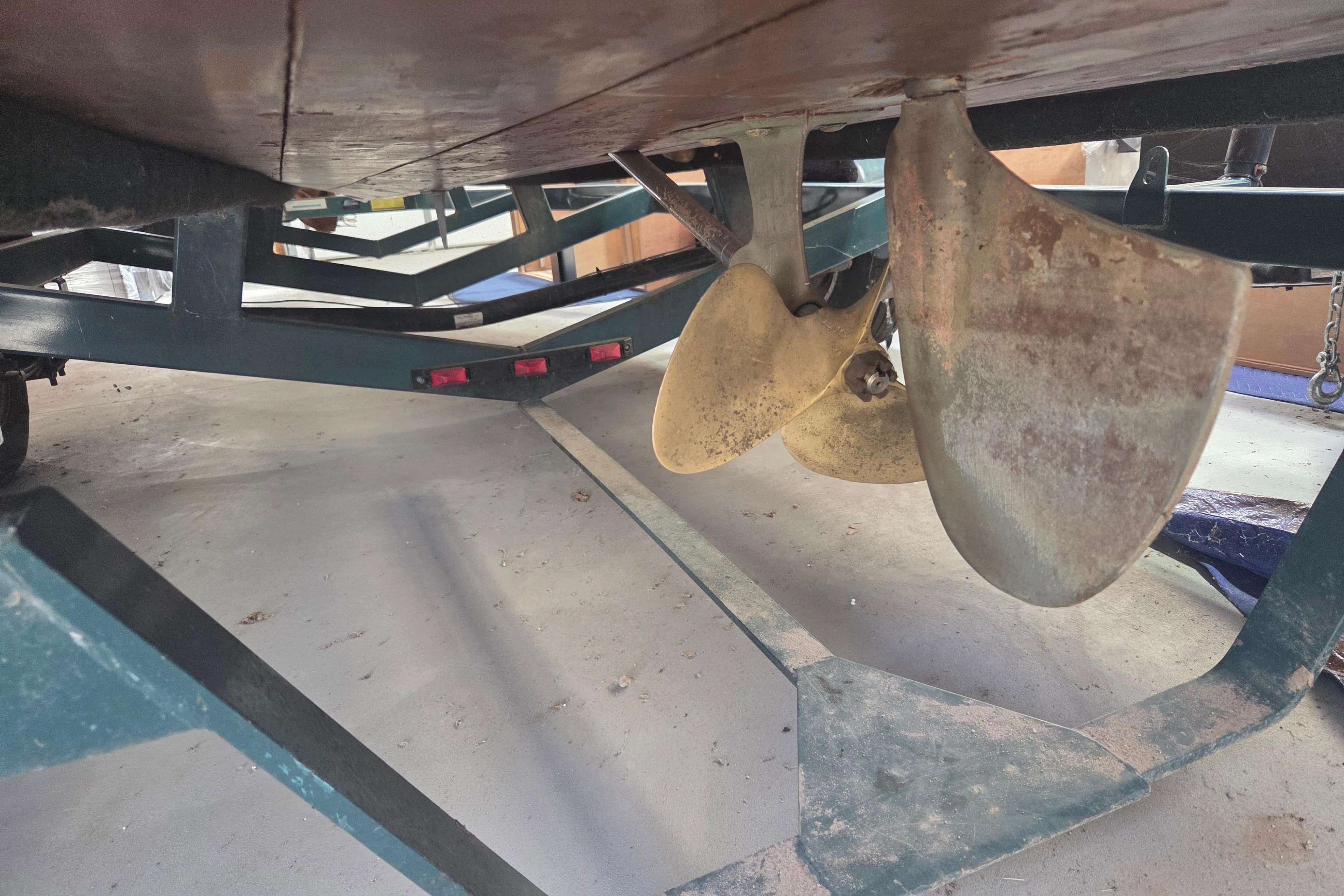 1960 Custom Chris Craft 19 Capri boat propeller on trailer, close-up view.