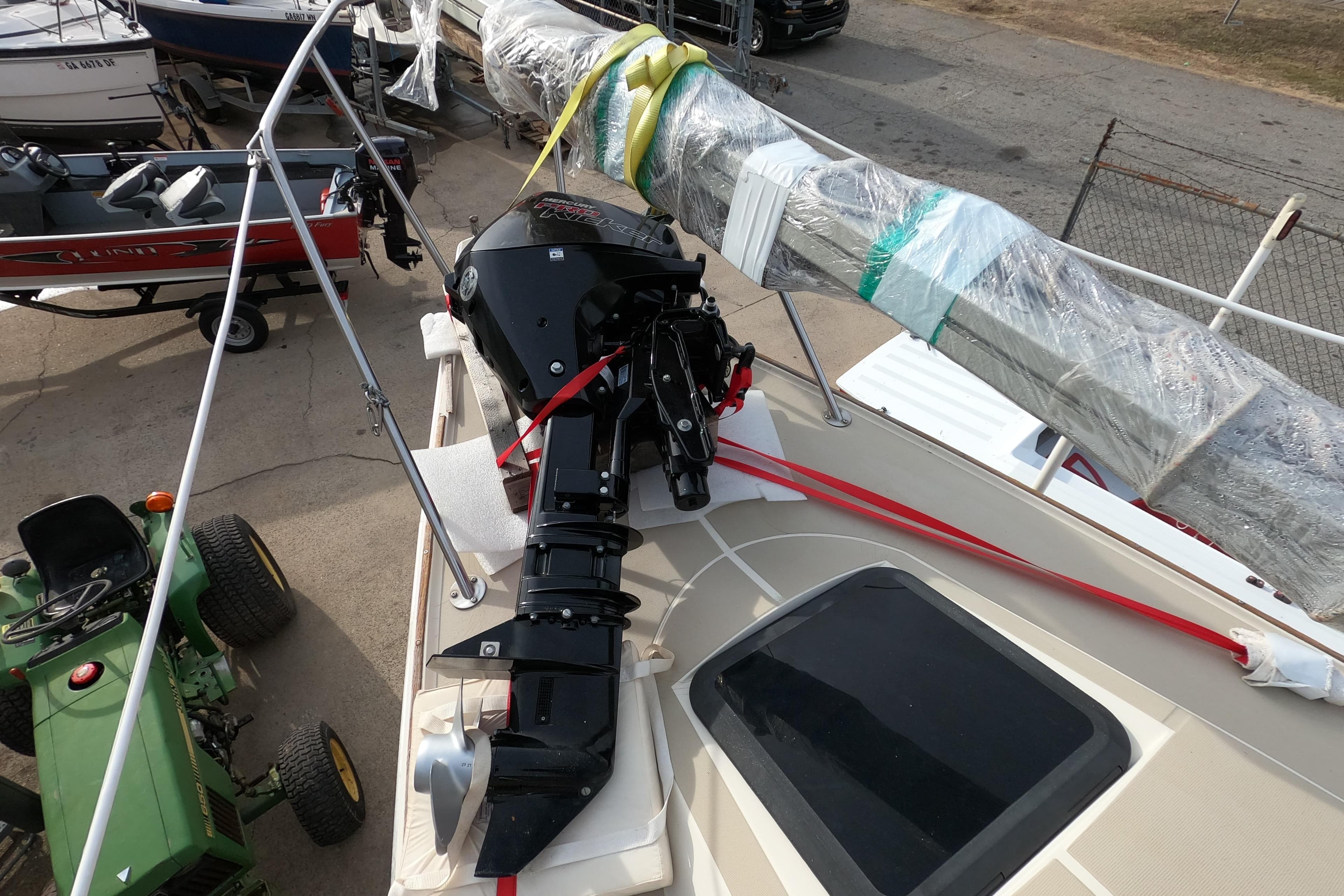 1985 Oday 272 sailboat with outboard motor and wrapped mast on deck.