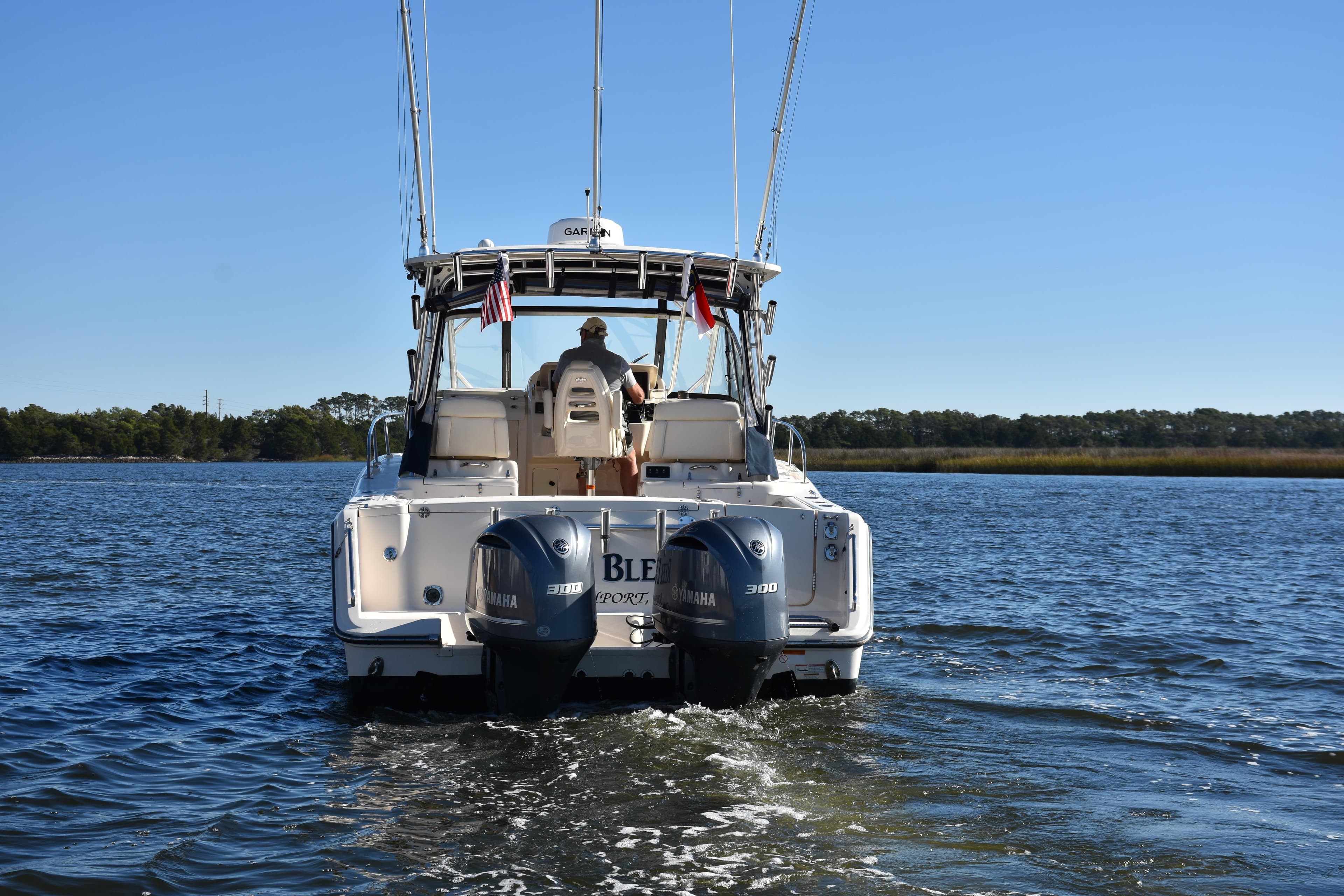 2017 Grady-White Express 330 boat cruising on a calm lake.