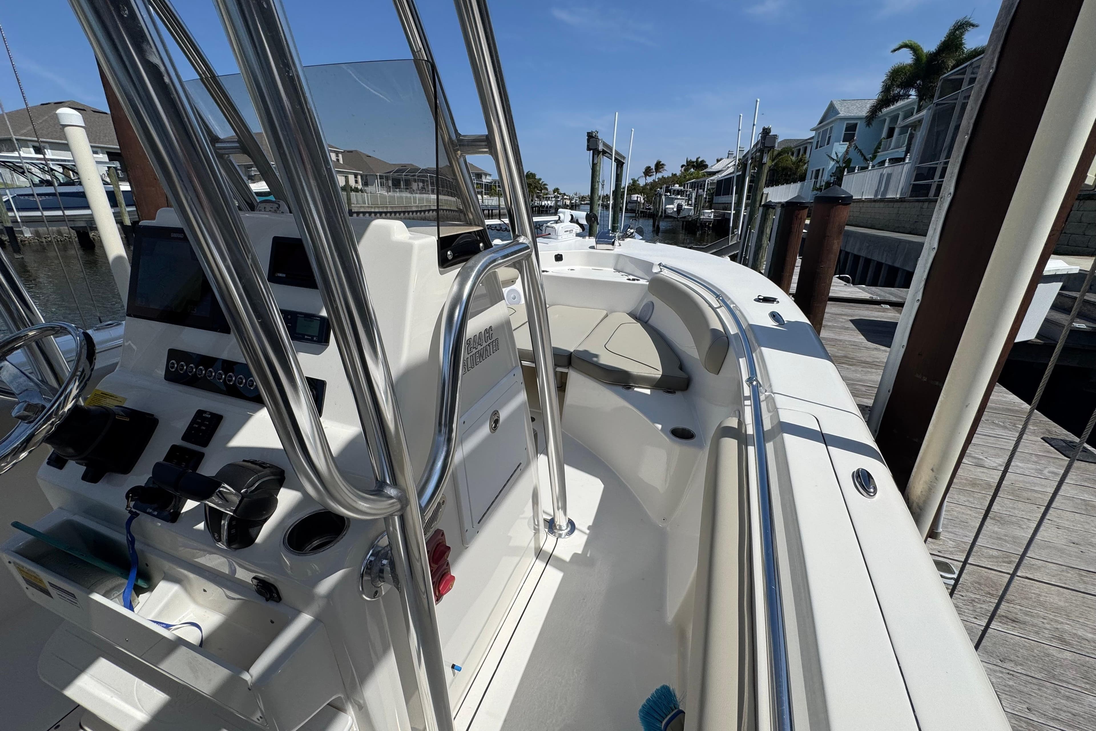2022 Key West 244 Center Console boat docked, showcasing helm and seating area.