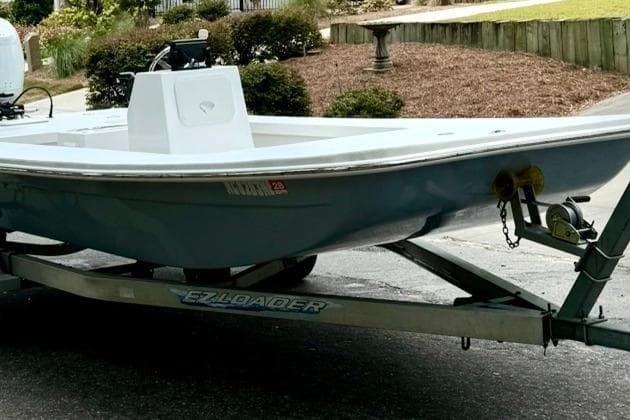 2025 Sea Skimmer 189 boat on EZ Loader trailer, parked outdoors.
