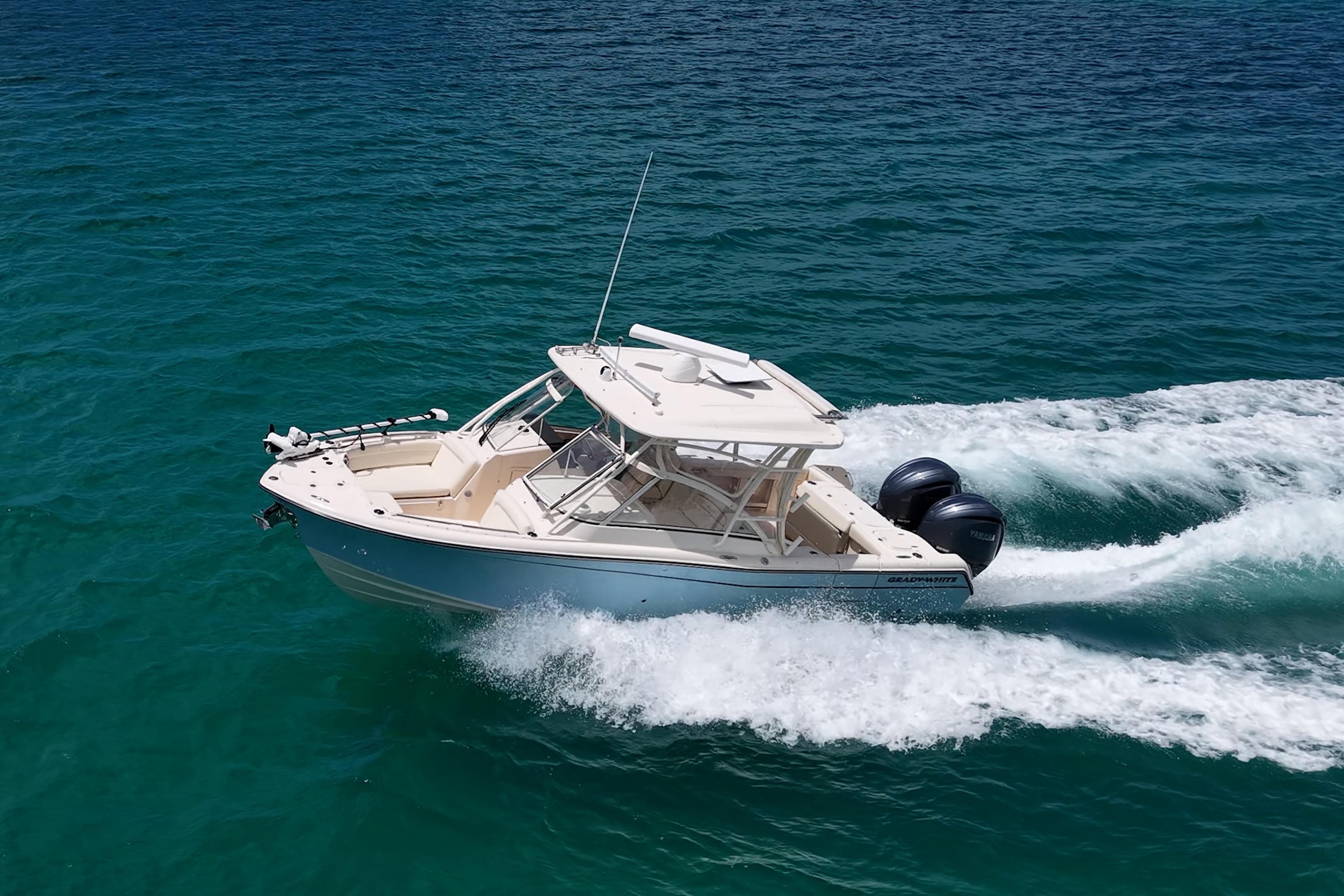 2022 Grady-White Freedom 285 boat cruising on clear blue water.