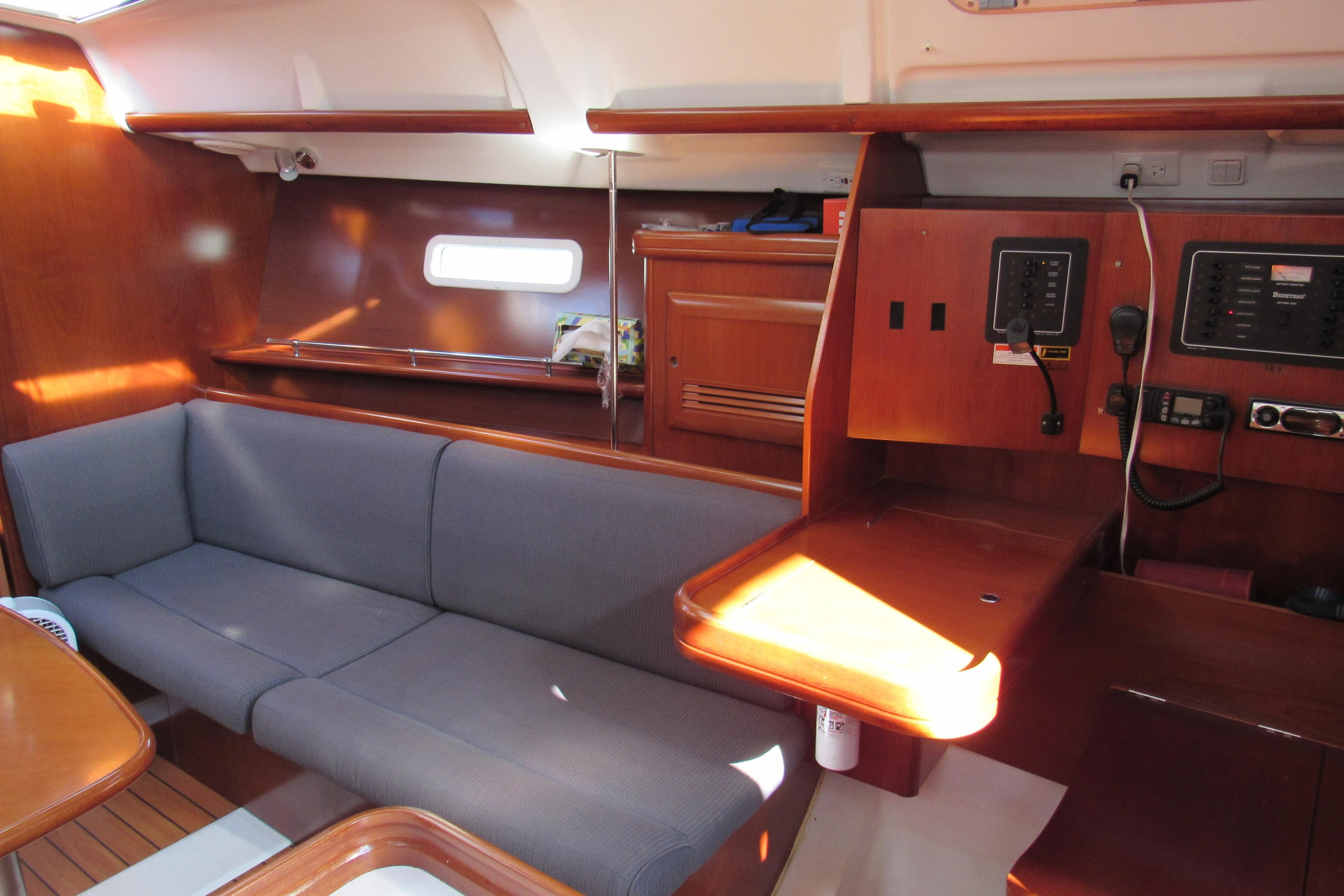 2005 Beneteau Oceanis 373 interior with wooden finish and comfortable seating.