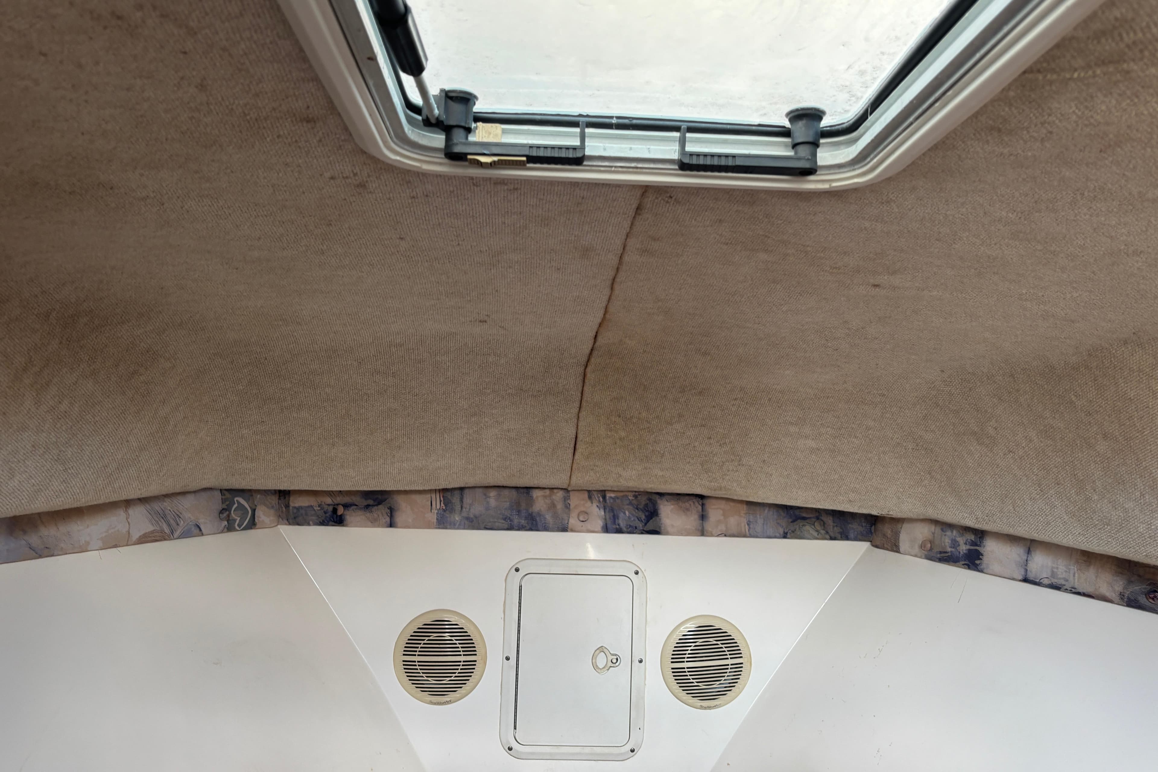 Interior cabin view of a 2000 Shamrock 260 Express boat with ceiling hatch.