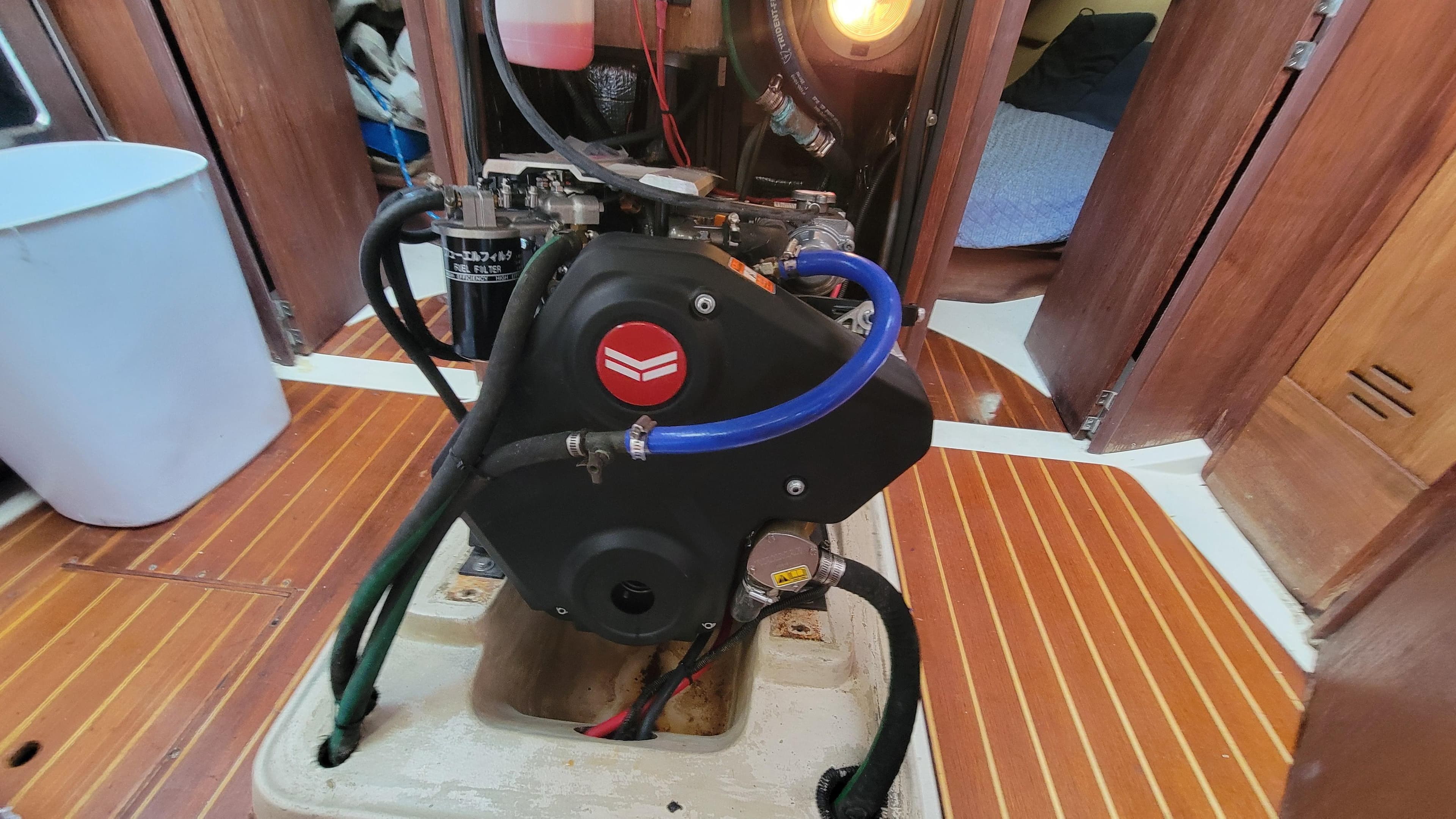 Engine compartment of a 1997 Hunter 37 sailboat, featuring a compact engine setup.