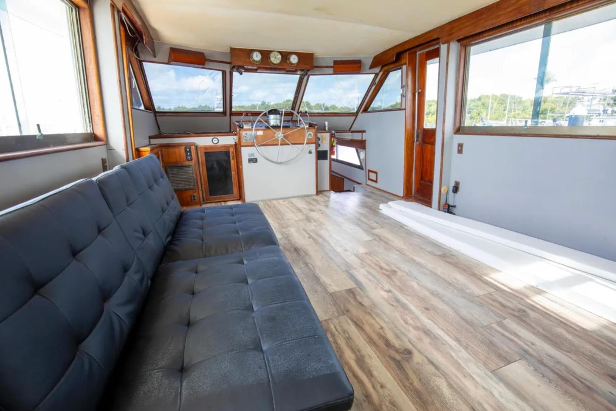 Interior of 1973 Hatteras 58 Yacht Fisherman with modern seating and wooden flooring.
