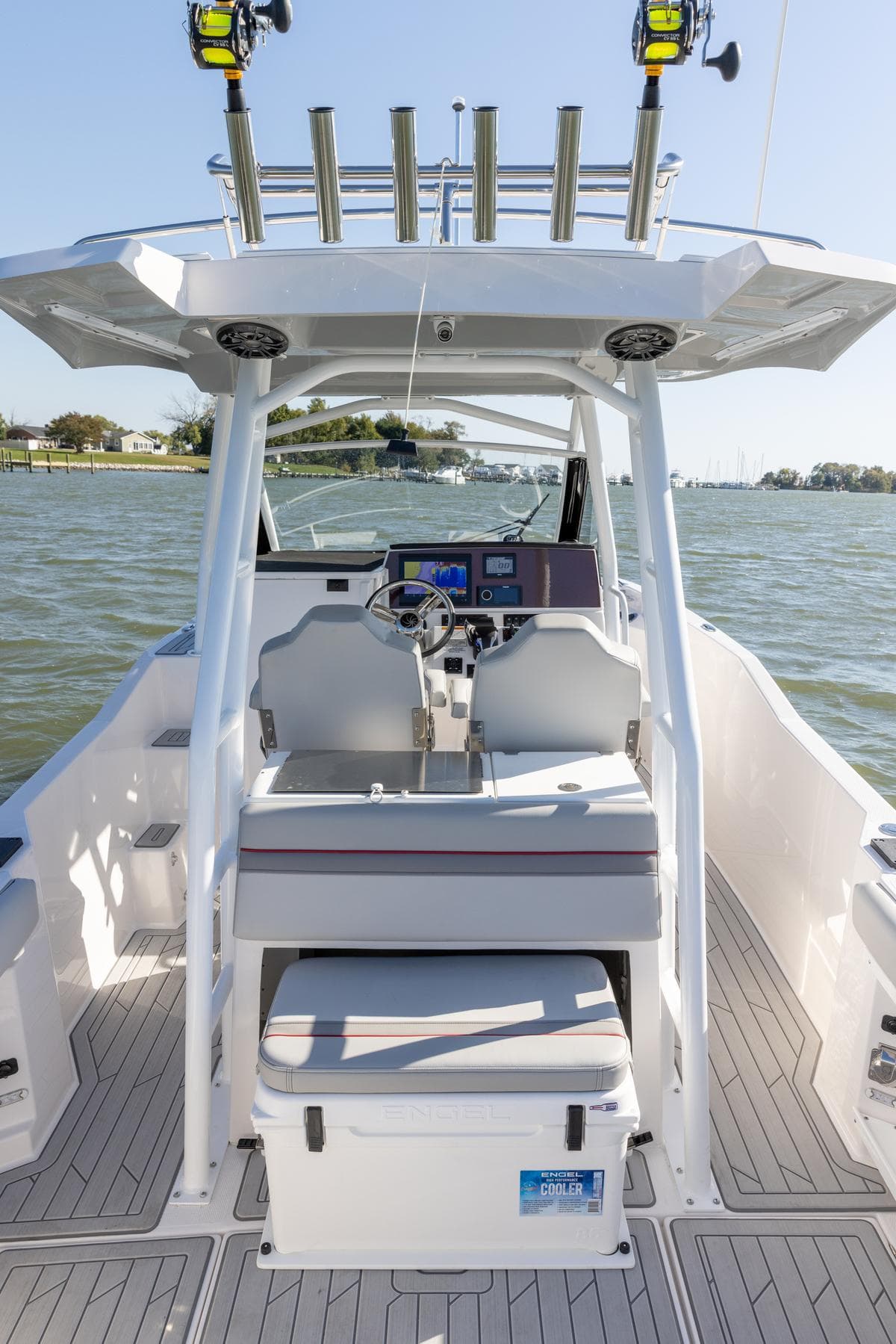 2026 Solara S-250 CW boat interior with helm, seats, and cooler on a sunny day.