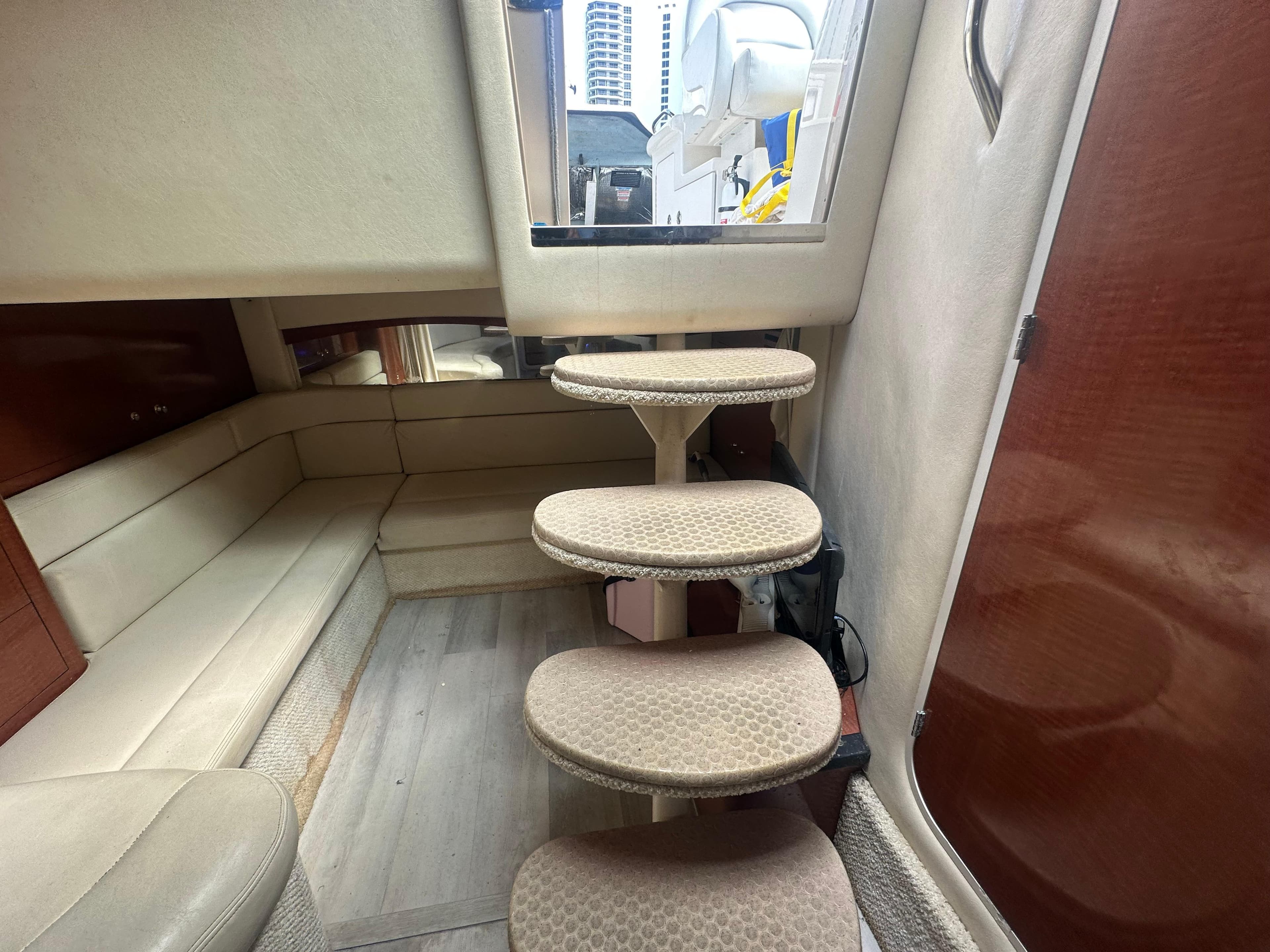 Interior of 2004 Sea Ray 340 Sundancer with beige seating and carpeted steps.