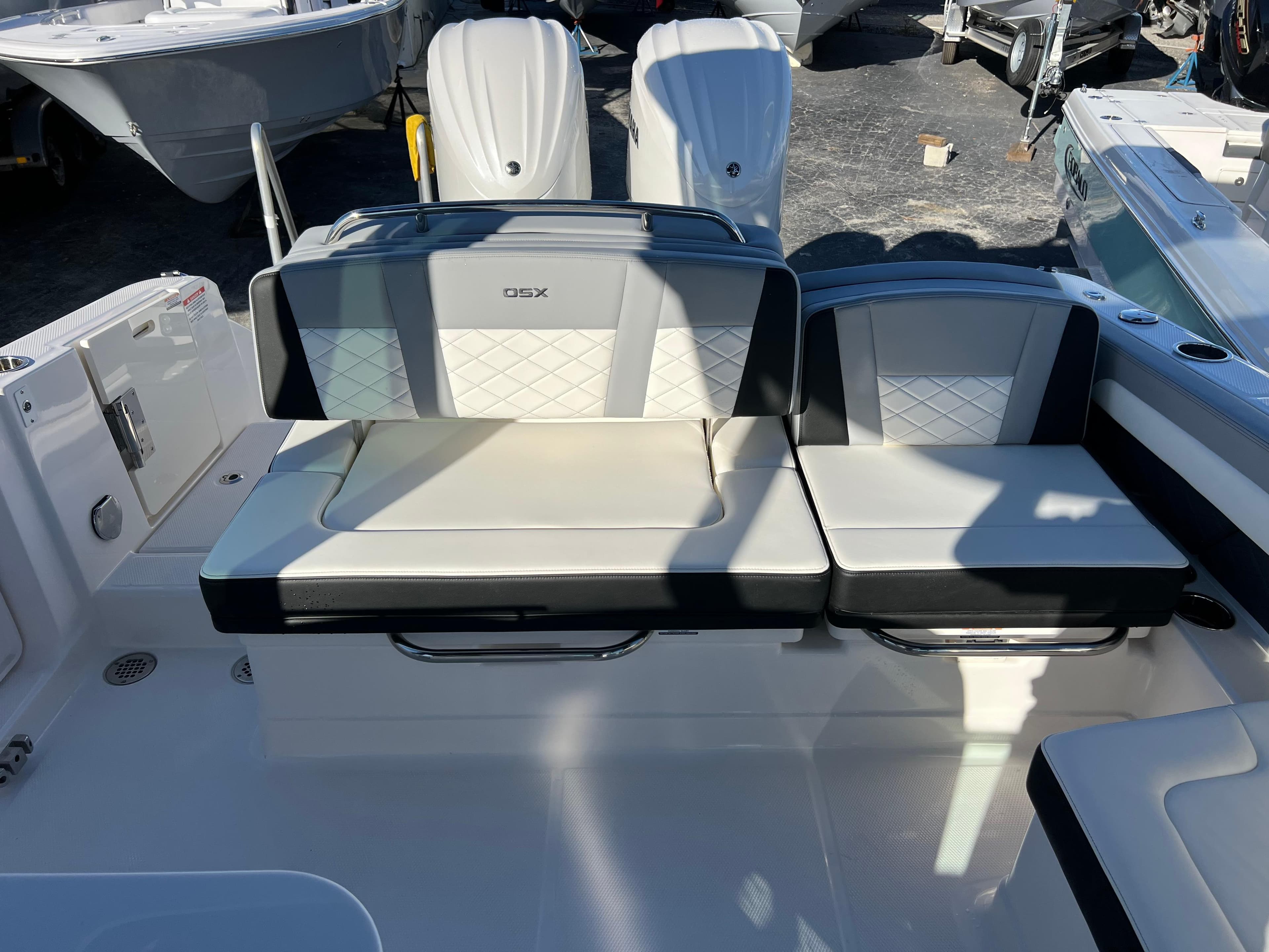 2025 Chaparral 310 OSX boat seating area with cushioned seats and backrests.