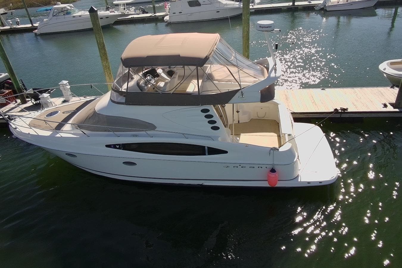 2003 Regal Commodore 3880 yacht docked at marina, aerial view.