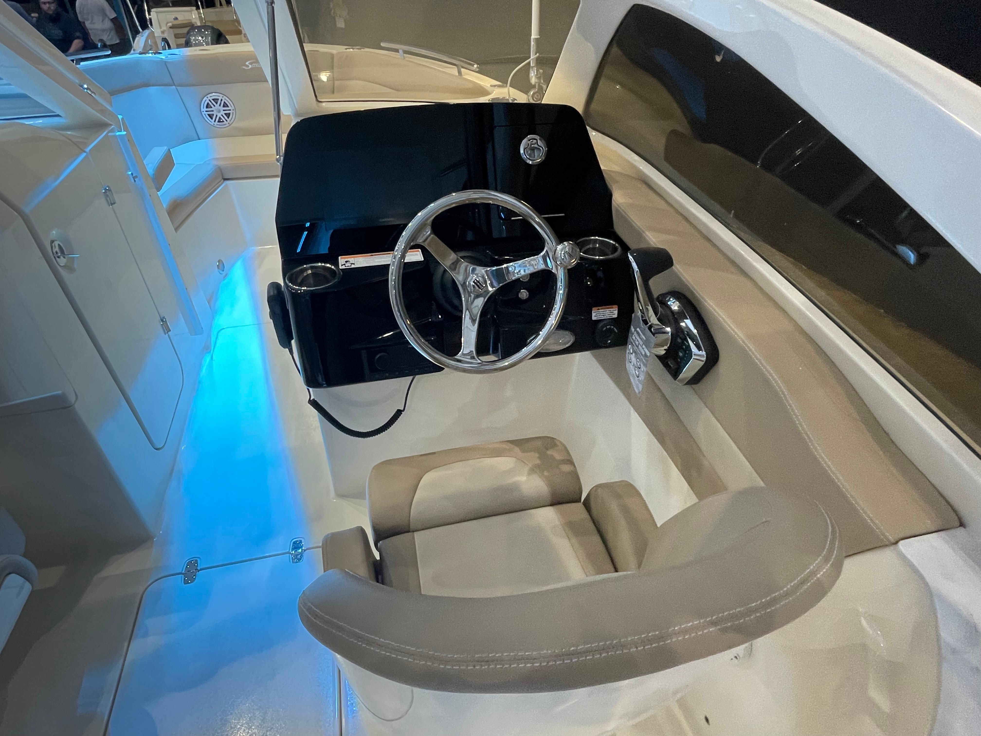 2024 Scout 240 Dorado boat helm with modern steering wheel and illuminated interior.