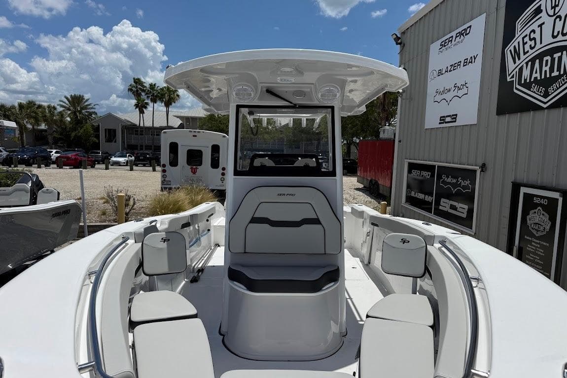 2026 Sea Pro 262 Offshore boat at marina, showcasing spacious seating and modern design.