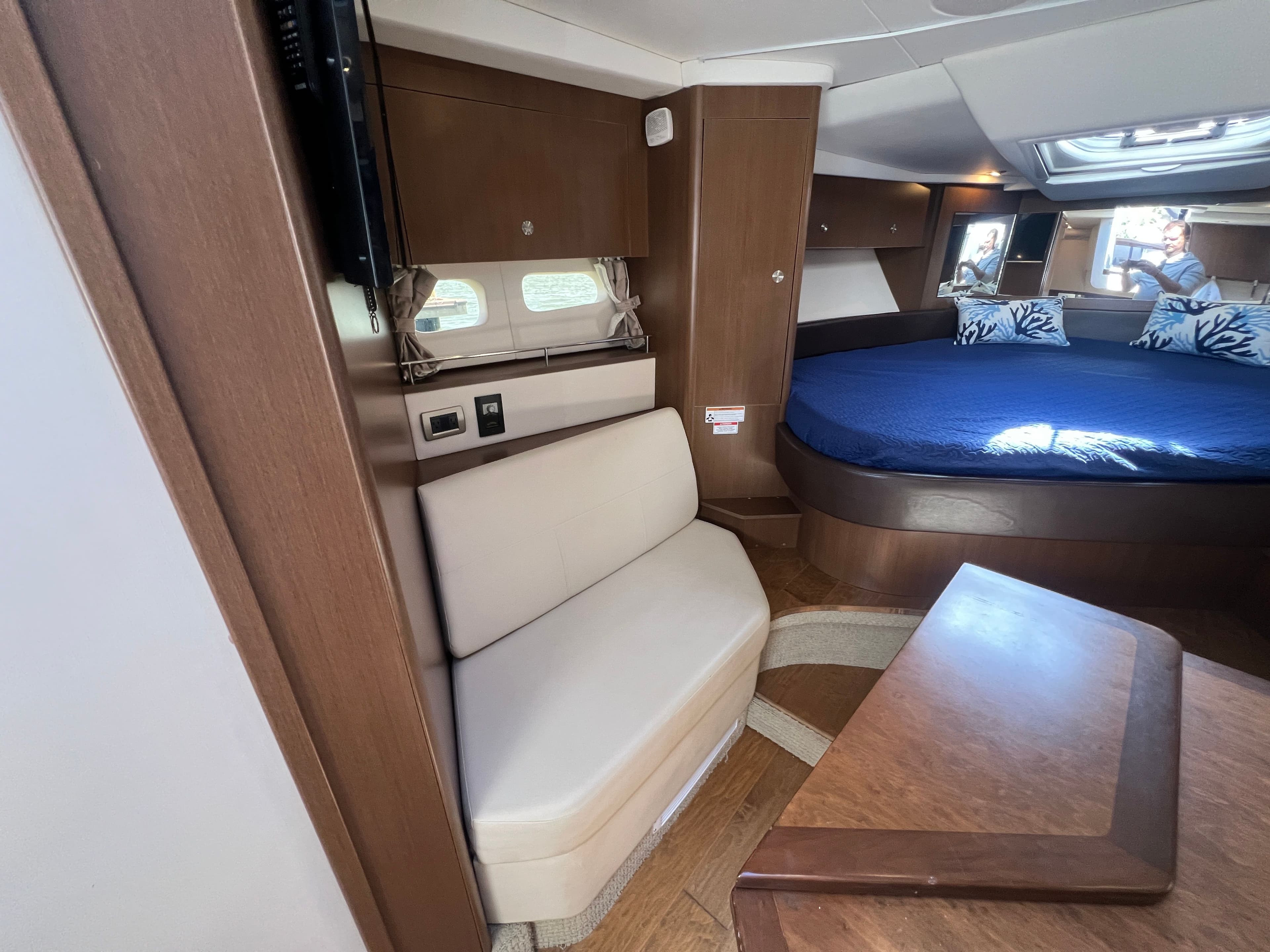 Interior of 2018 Sea Ray Sundancer 350 Coupe with bed and seating area.