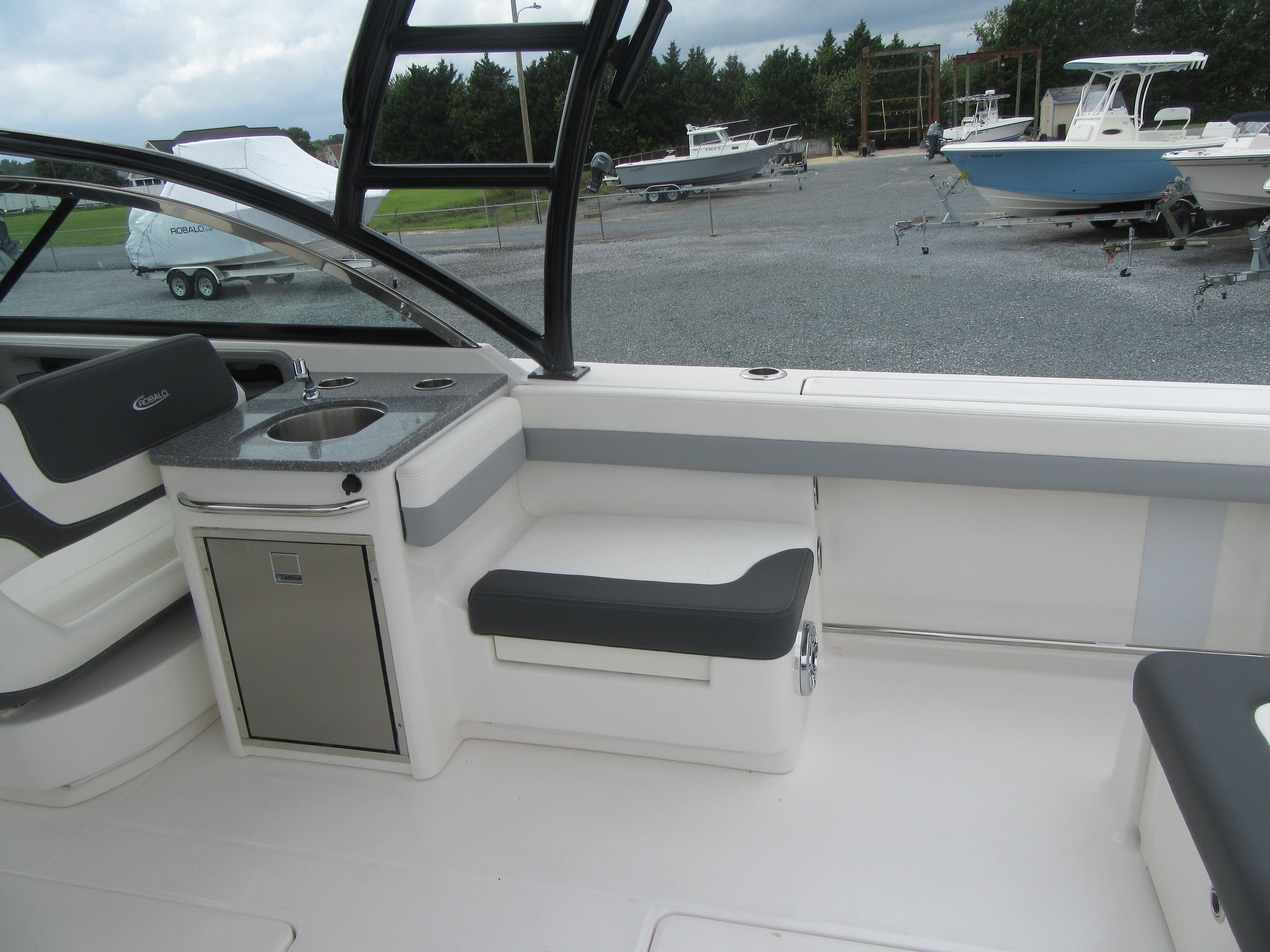 2024 Robalo R317 Dual Console boat interior with seating and sink.