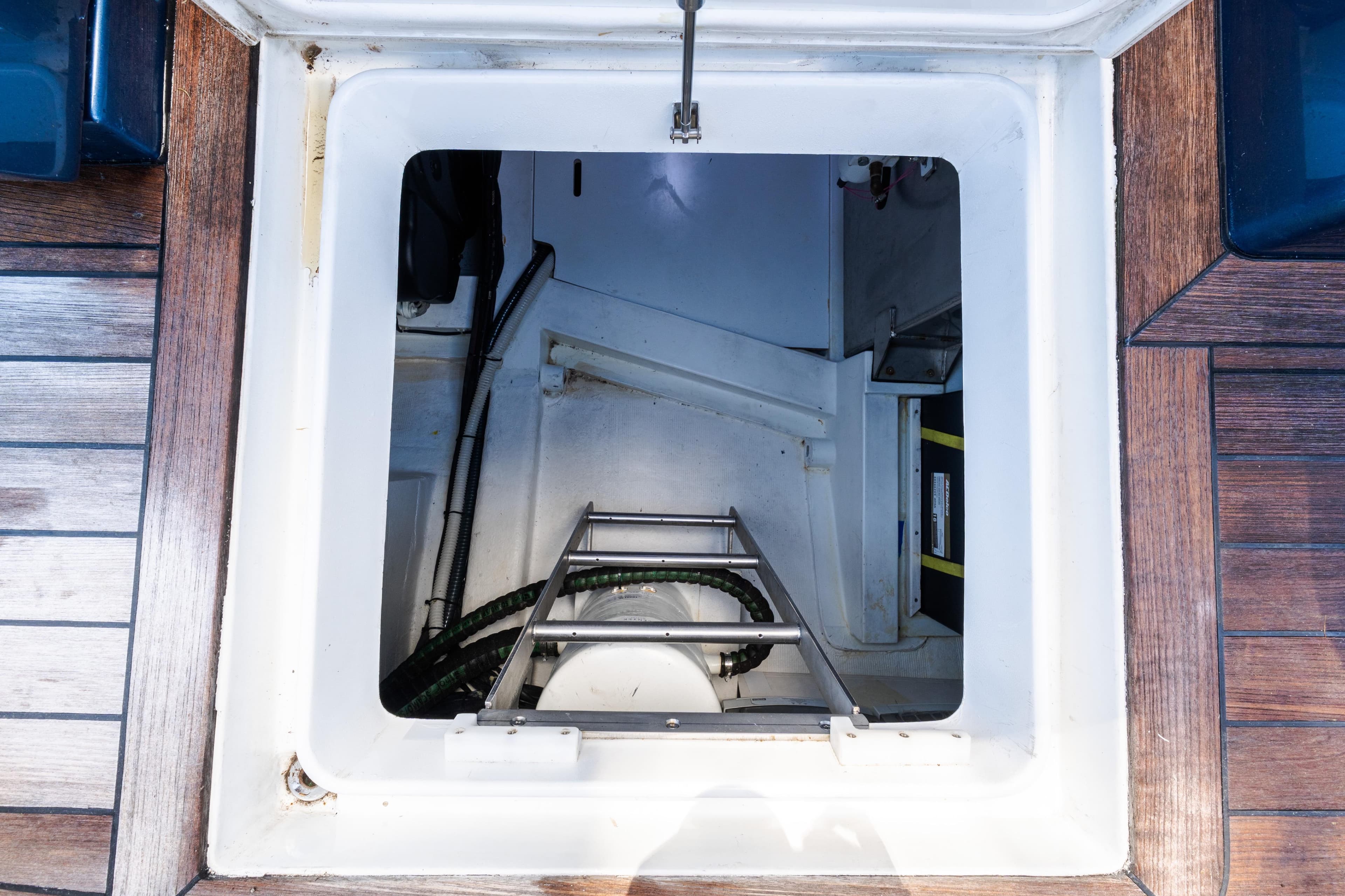 Engine compartment access on 2023 Solaris Power 44 Open yacht with wooden deck.