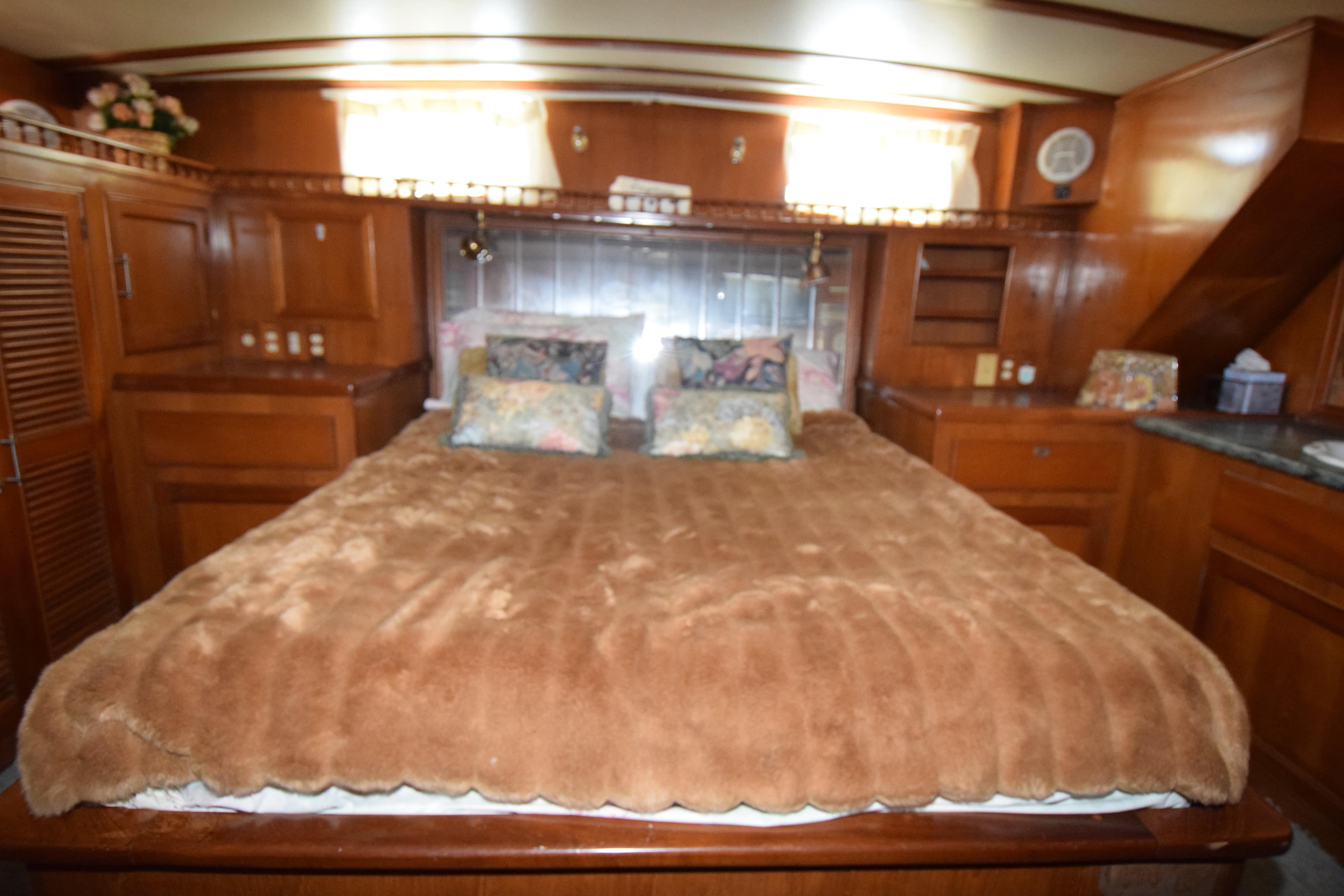 Luxurious bedroom interior of 1988 Sea Ranger 51 Motor Yacht with plush bedding.