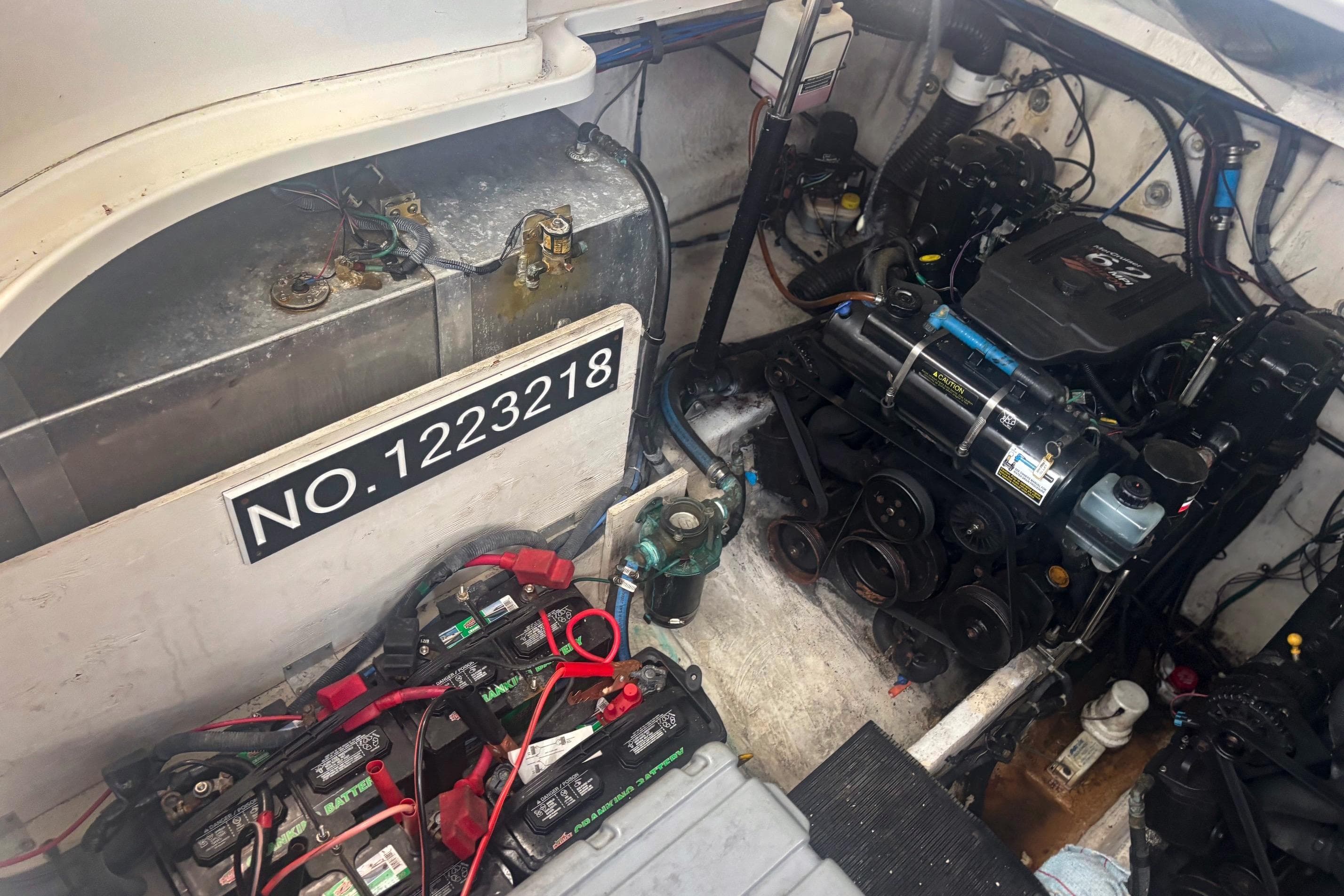 Engine compartment of a 2006 Sea Ray 320 Sundancer with visible components and serial number.
