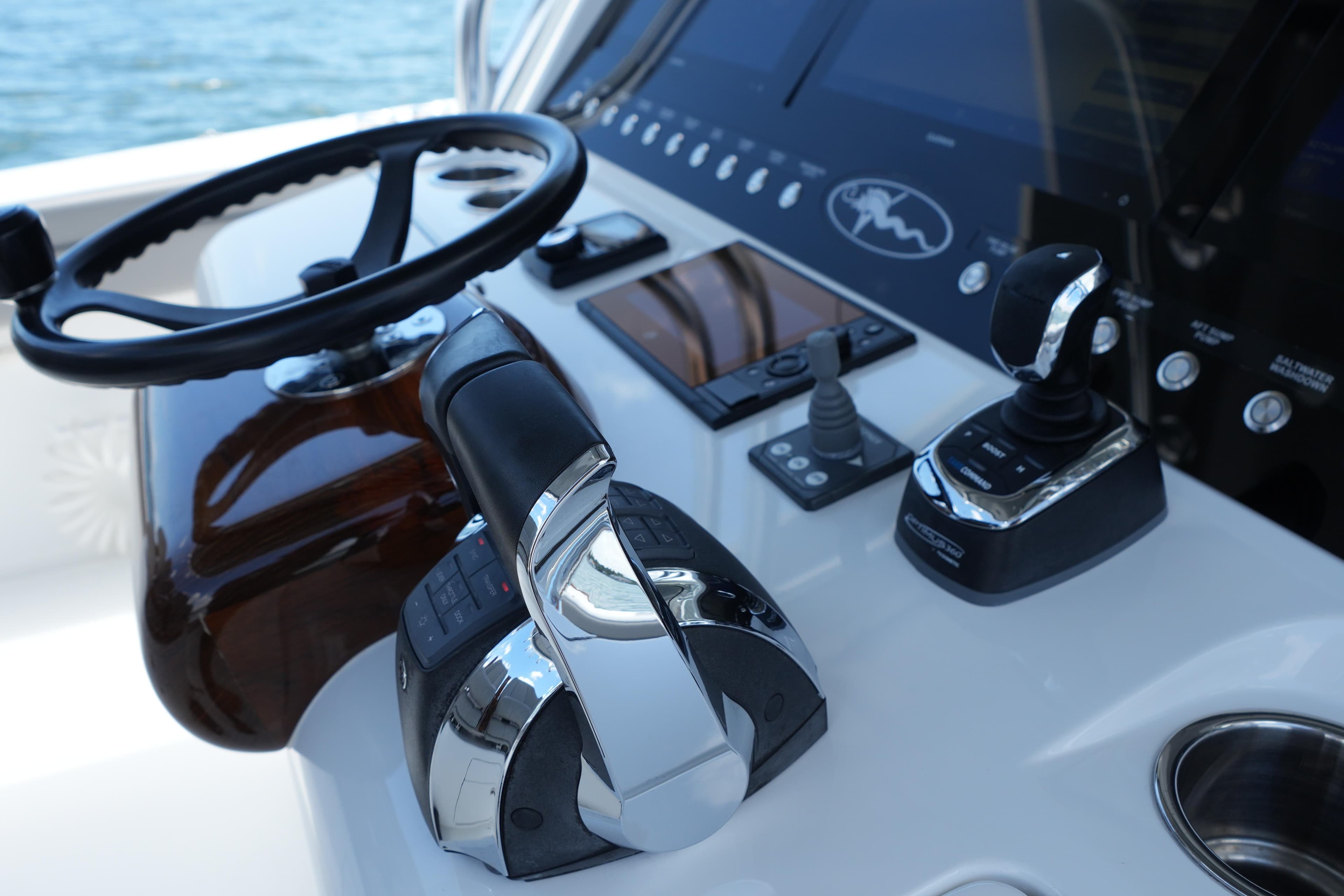 Control panel of 2022 Valhalla Boatworks V-41 with steering wheel and throttle controls.