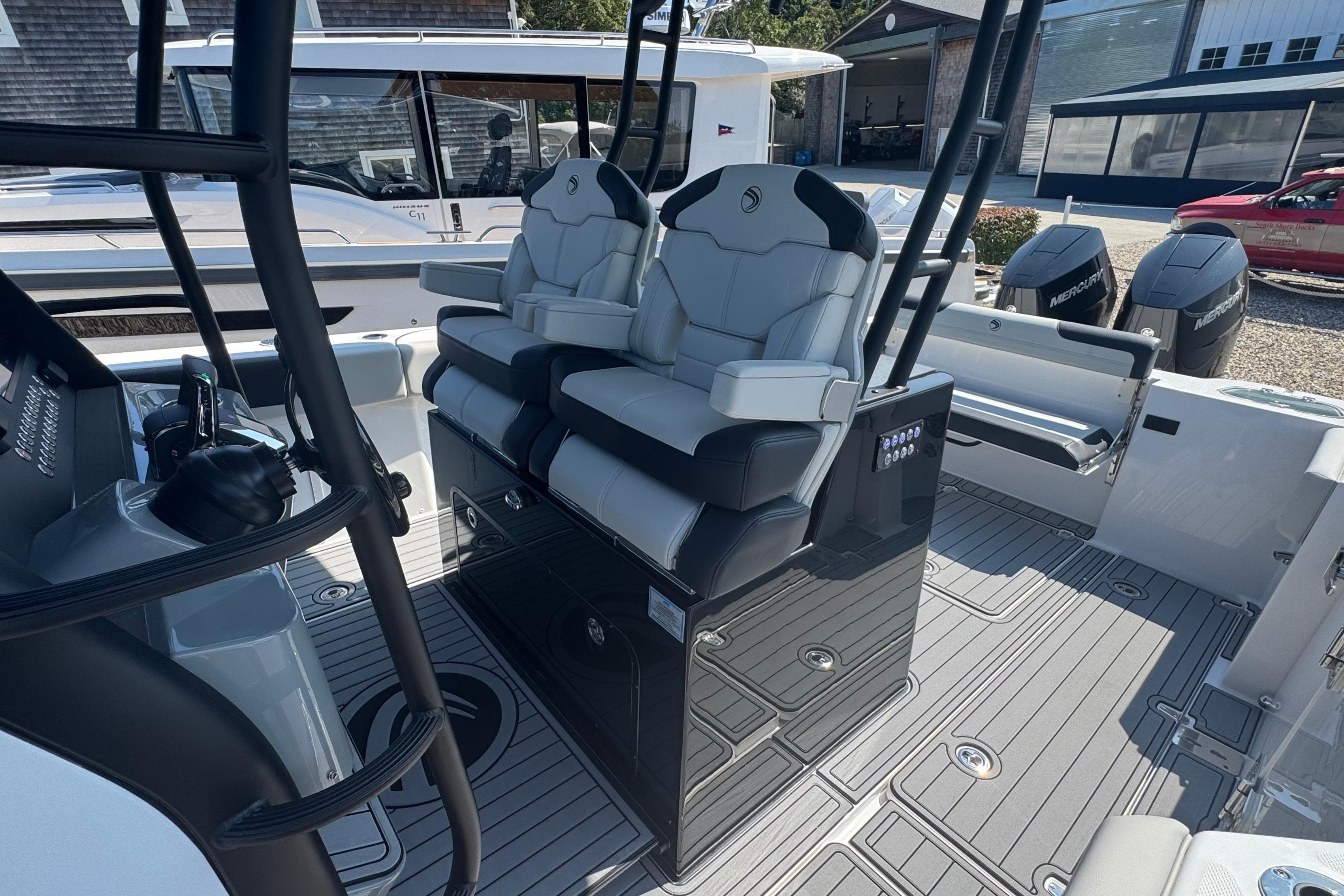 2025 Edgewater 340CC boat interior with dual captain's chairs and modern controls.