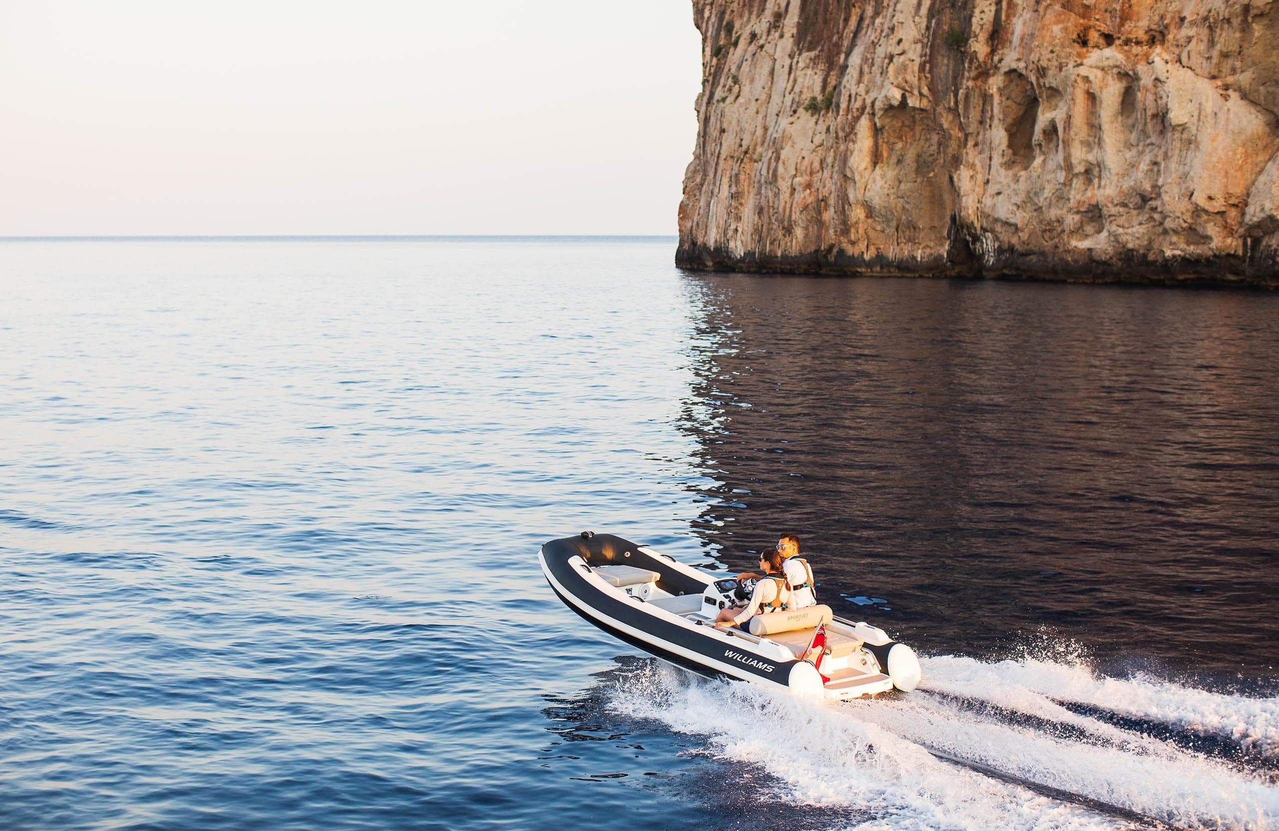 2025 Williams Jet Tenders Sportjet 435 cruising near a rocky coastline.