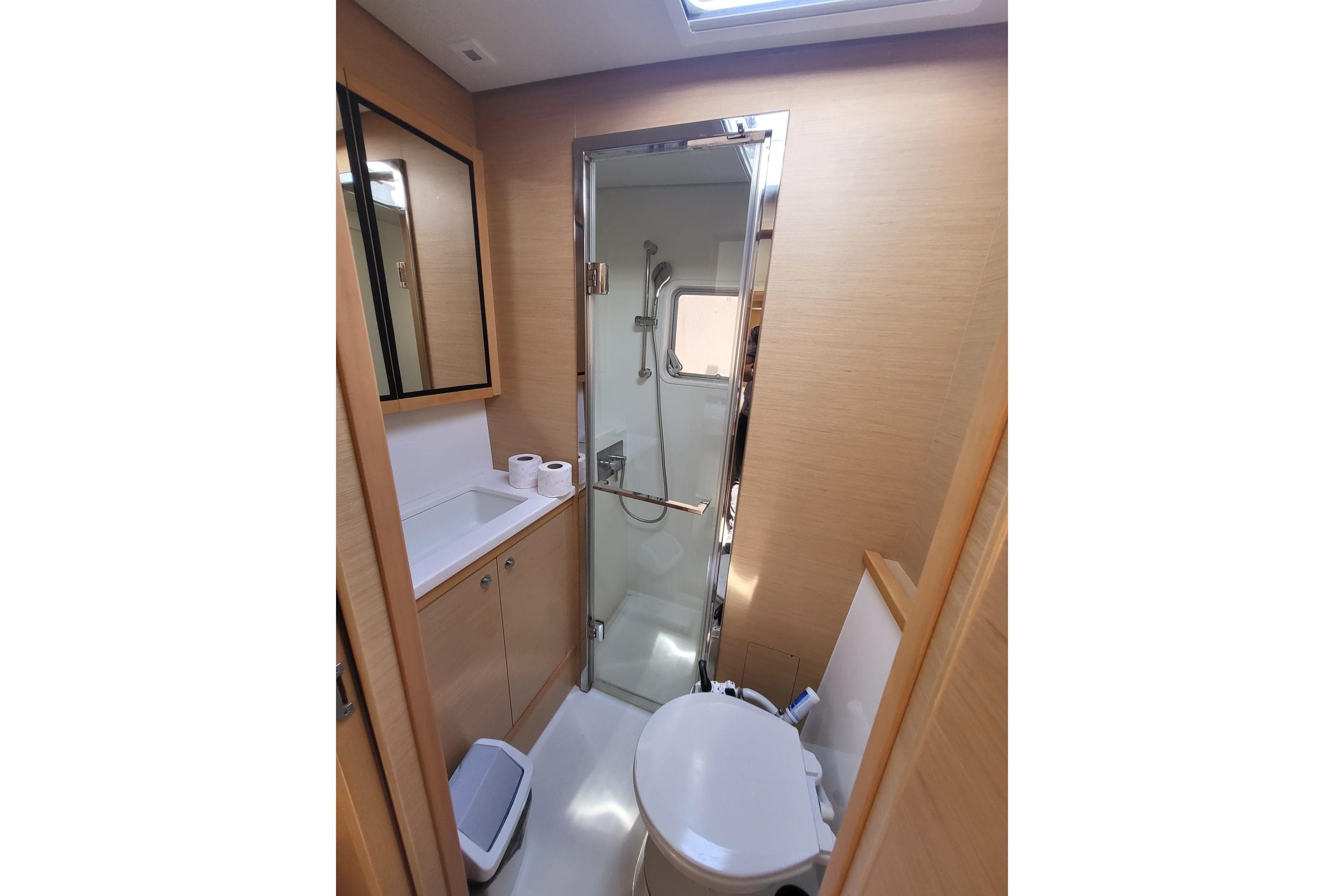 Modern bathroom in 2017 Lagoon 52 F yacht with shower and toilet.