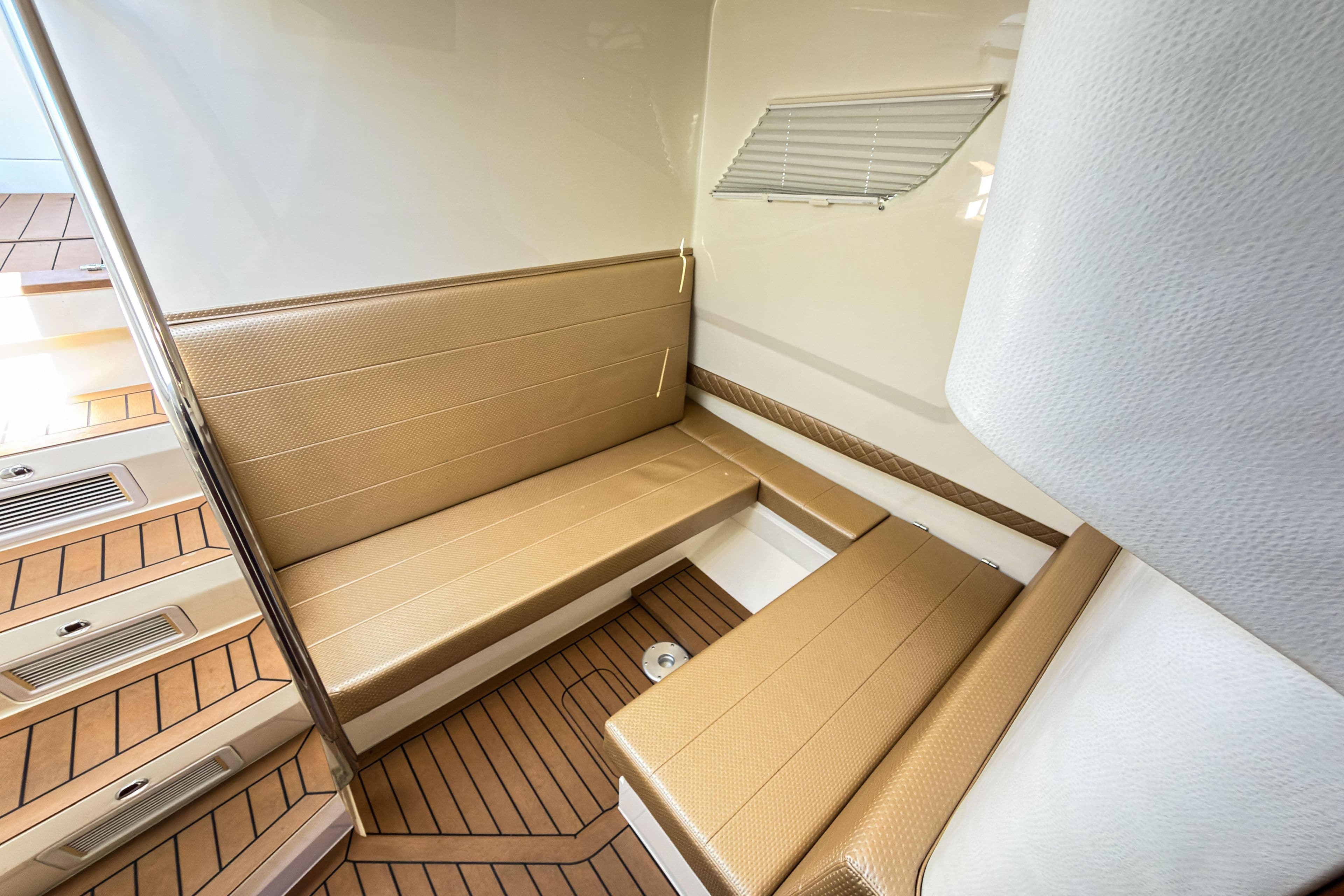 2016 SeaVee 430 interior with tan seating and wood-patterned flooring.