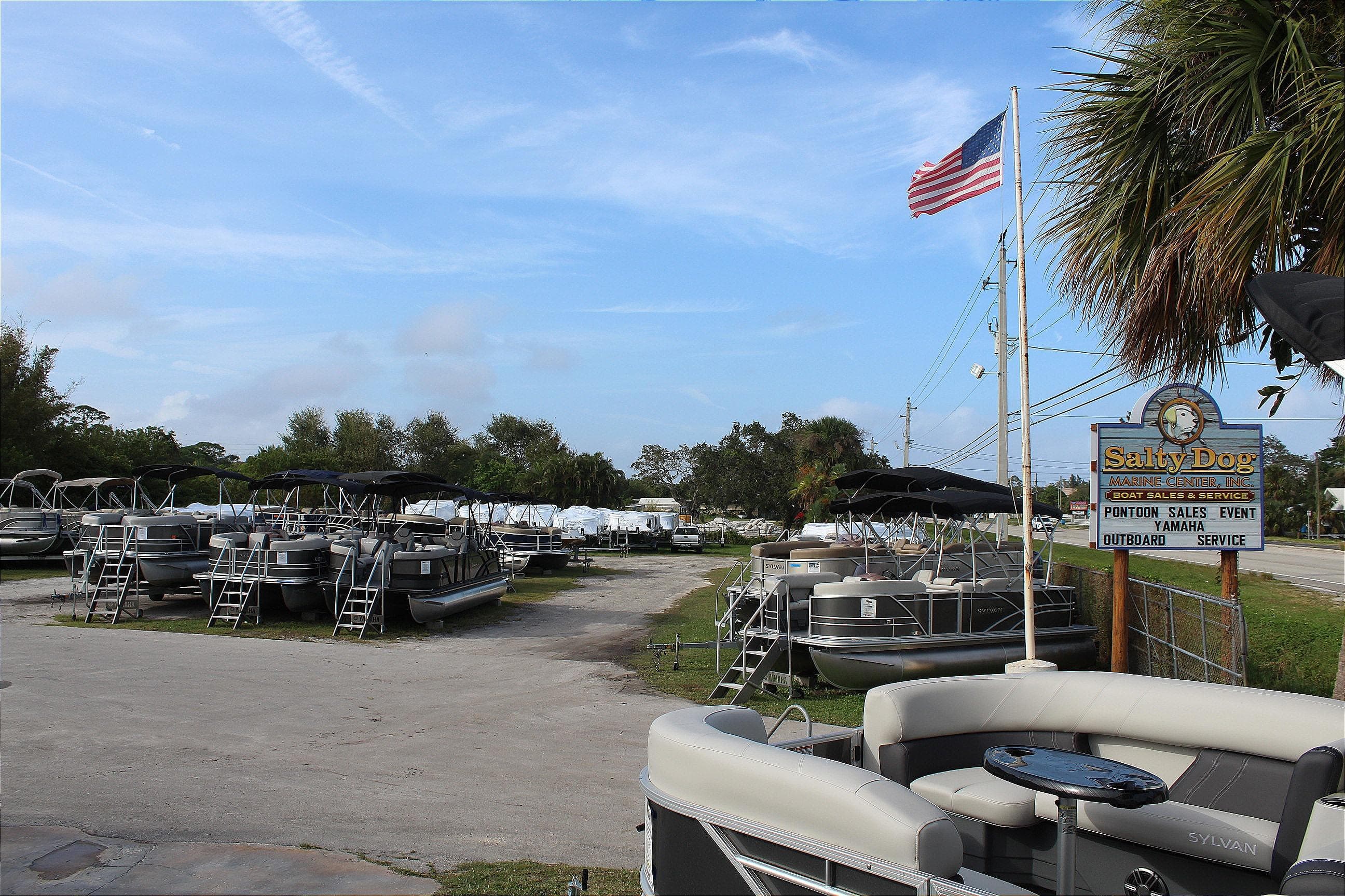 Outdoor display of 2019 Sylvan Mirage Fish 8520 Party Fish pontoon boats at Salty Dog Marine Center.