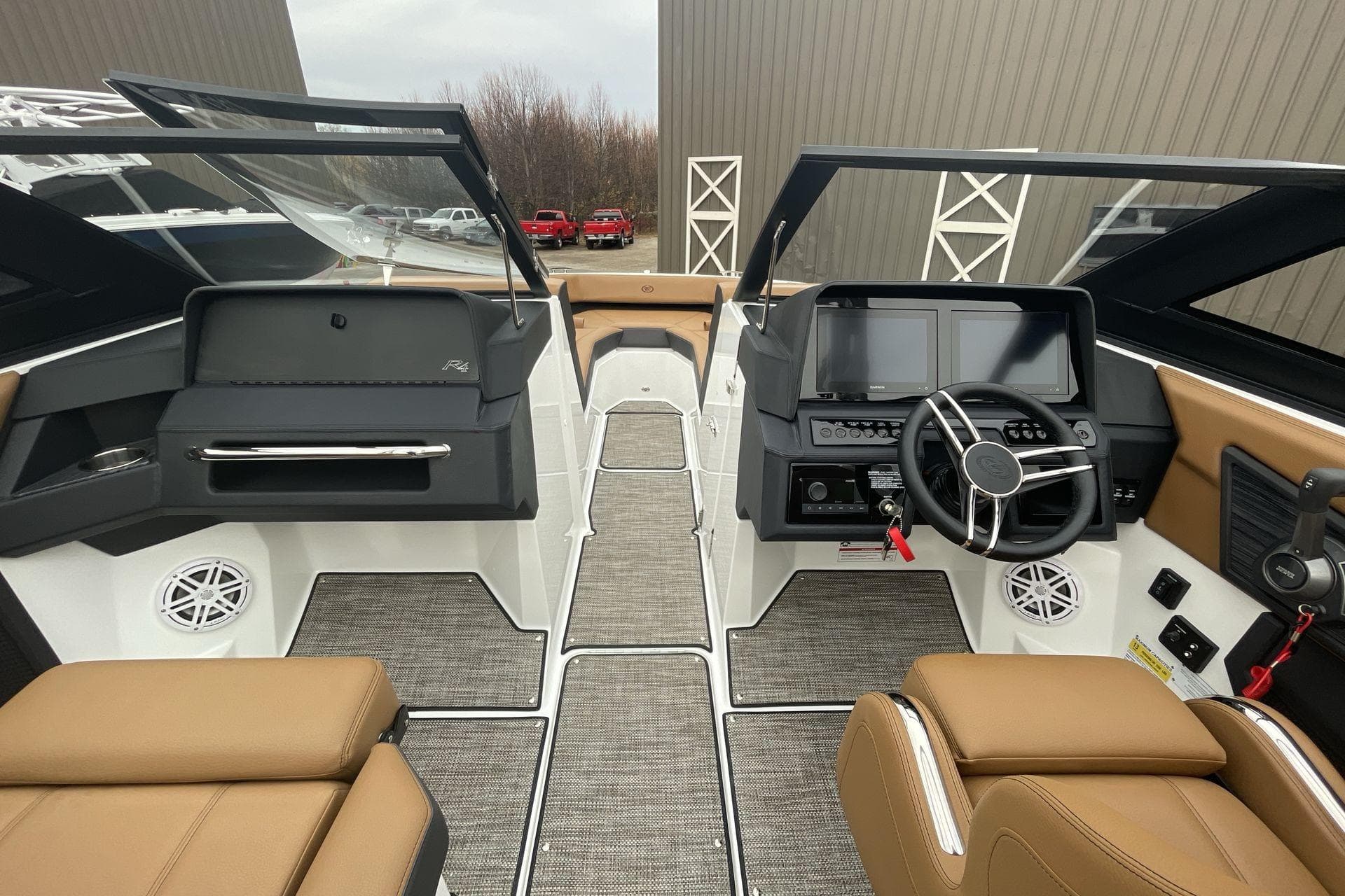 2025 Cobalt R4 Surf boat interior with modern dashboard and tan seating.