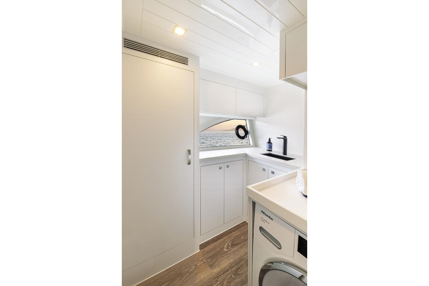 Modern laundry area in 2026 Riviera 64 Sports Motor Yacht Series II.
