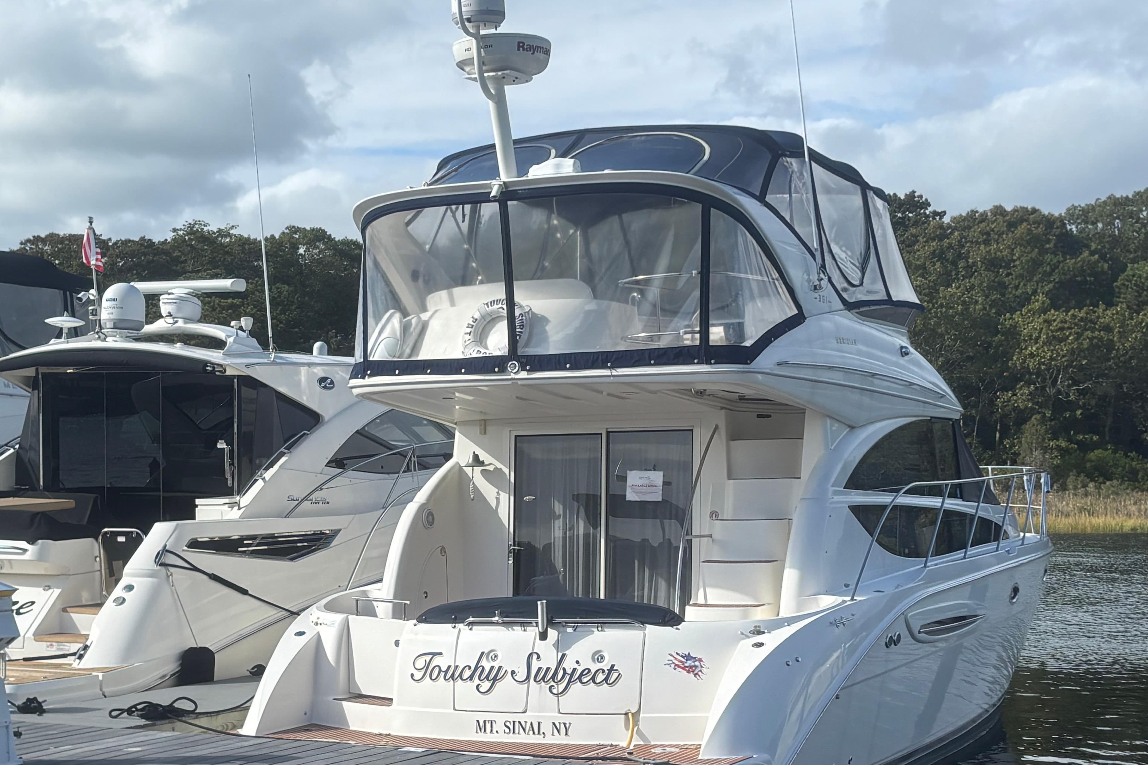 2007 Meridian 391 Sedan yacht docked, featuring sleek design and spacious upper deck.