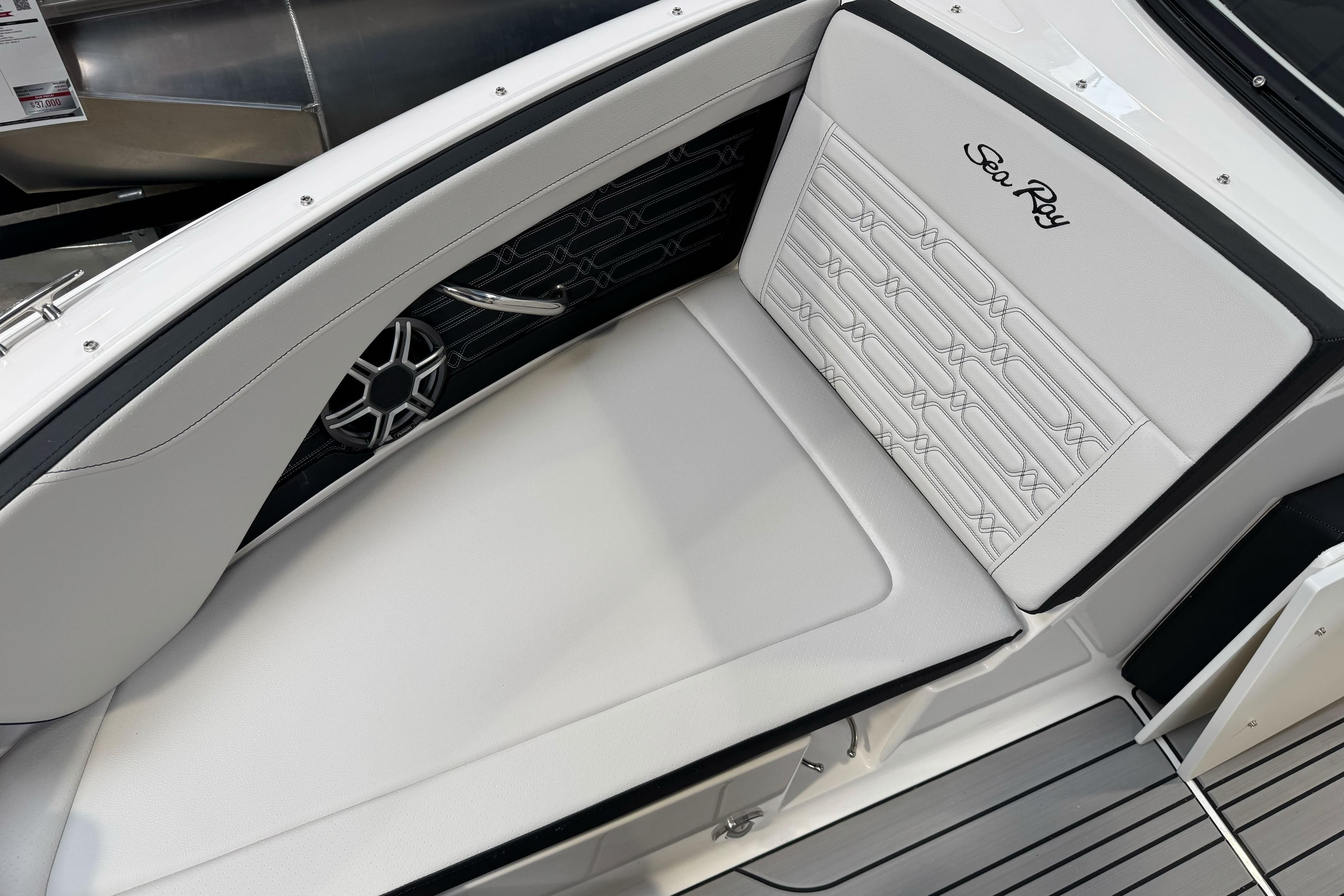 2026 Sea Ray SPX 210 boat interior with white cushioned seating and sleek design.