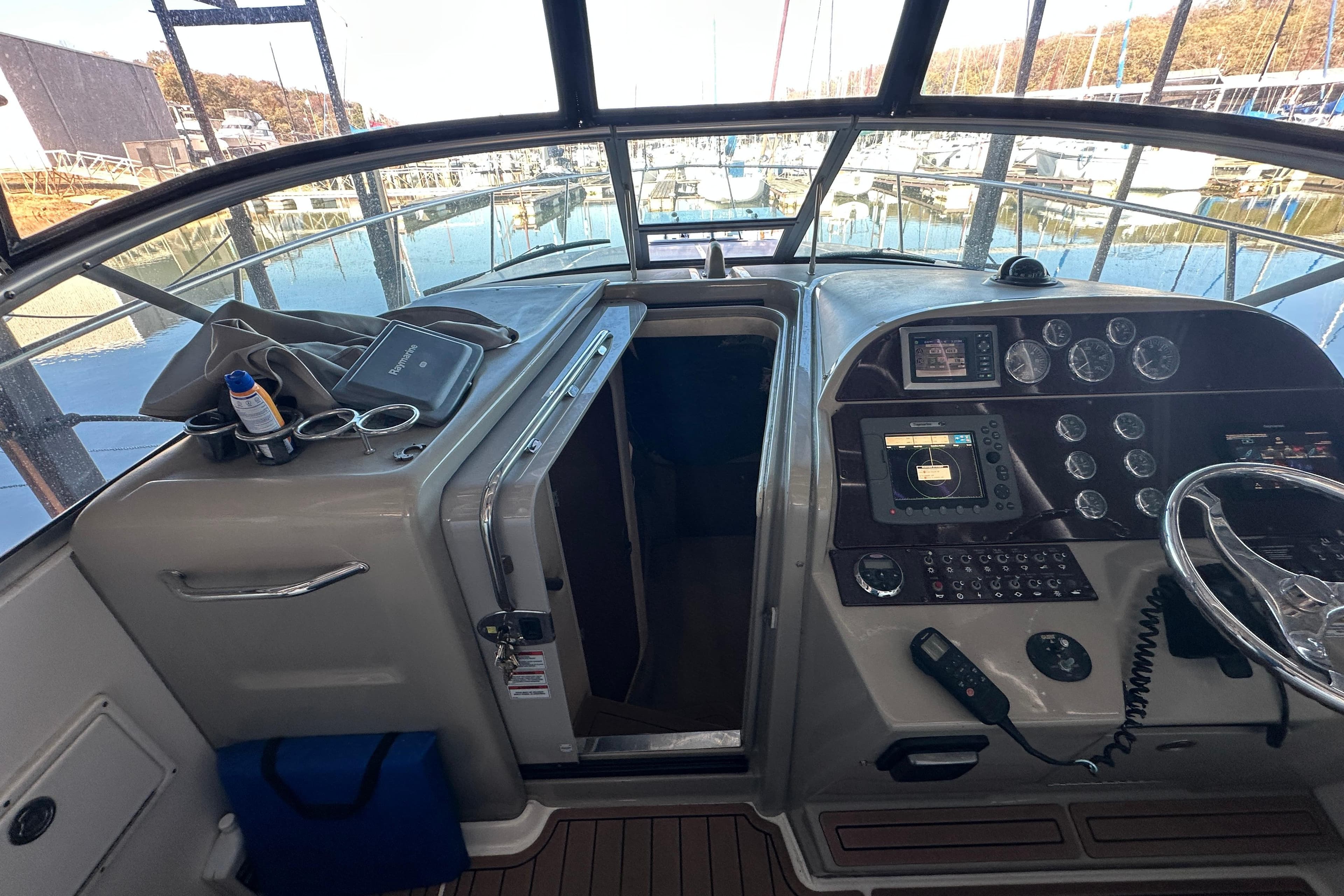 2008 Sea Ray 290 Amberjack cockpit with navigation instruments and marina view.