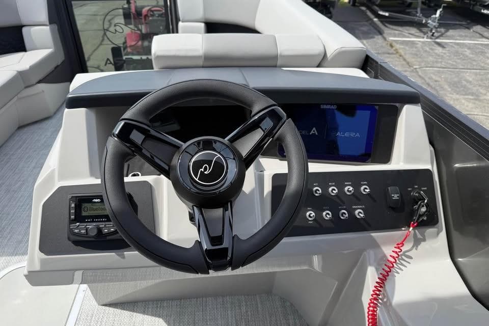 Steering console of 2026 Alera 22l boat with modern controls and display.