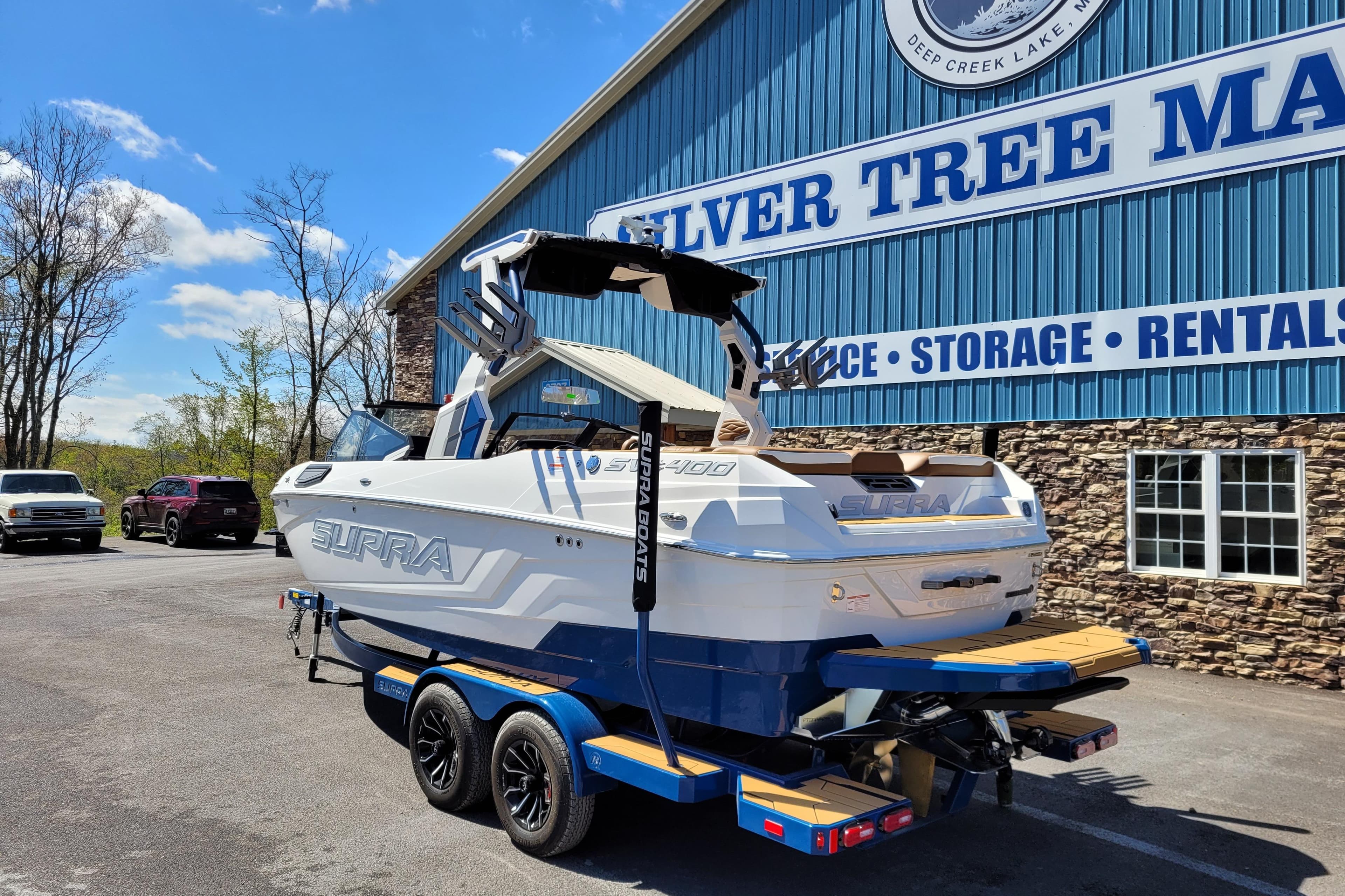 2026 Supra SV 400 boat on trailer at Silver Tree Marine, sunny day.