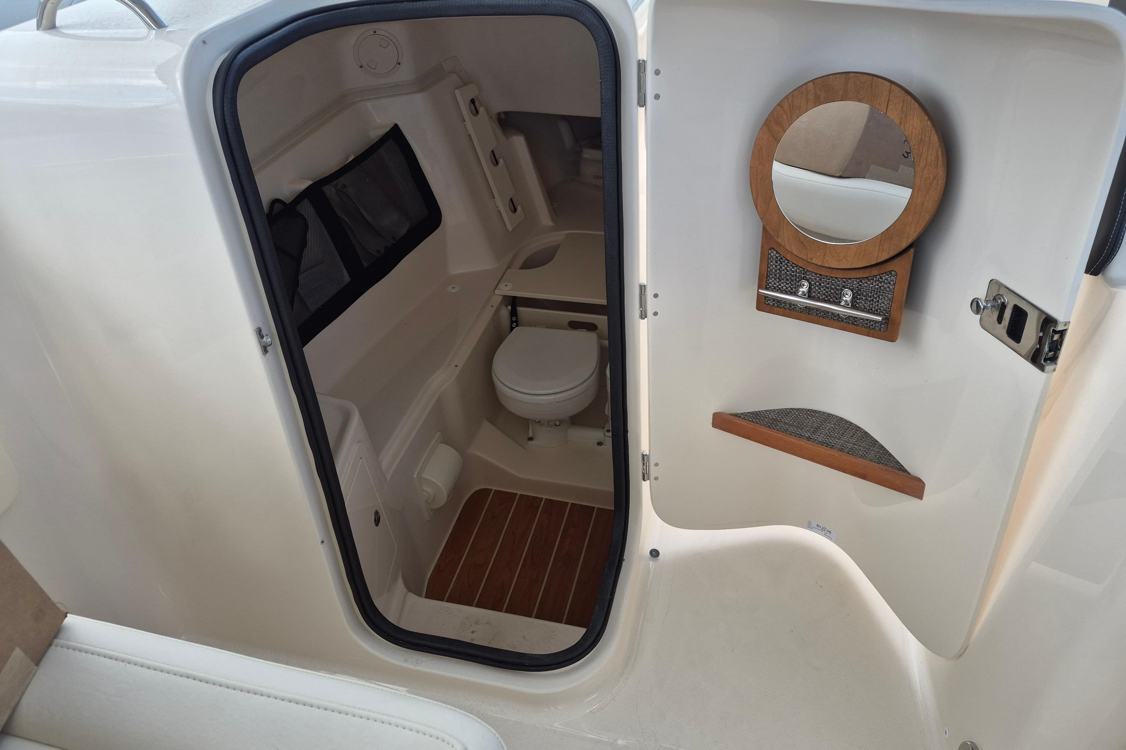 2026 Grady-White Freedom 307 boat interior with toilet and mirror.
