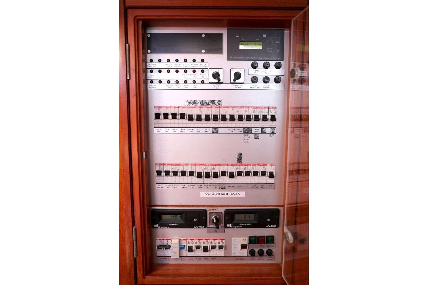 Electrical control panel on a 1996 Nautor Swan 48 yacht, featuring switches and meters.